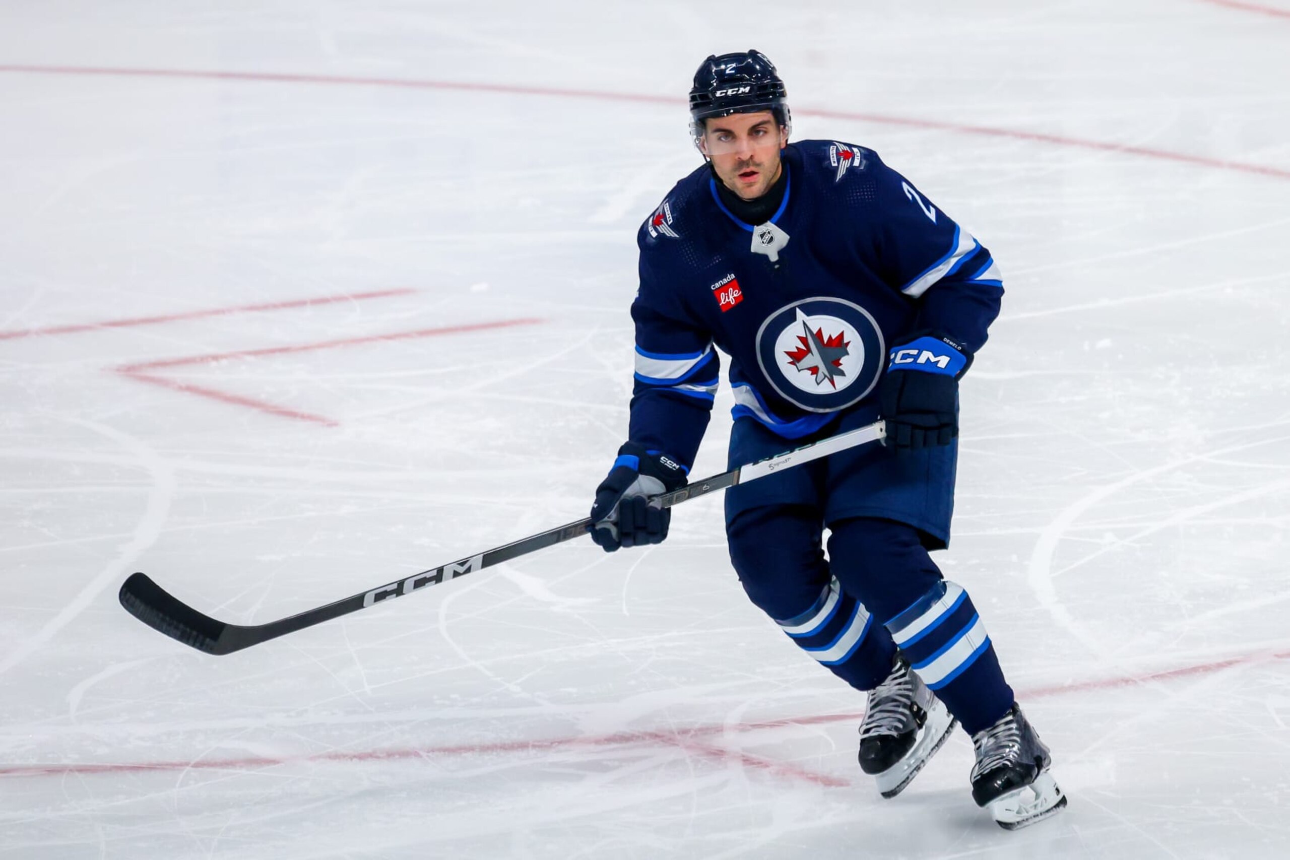 WINNIPEG, CANADA - APRIL 23: Dylan DeMelo #2 of the Winnipeg Jets skates during third period action against the Colorado Avalanche in Game Two of the First Round of the 2024 Stanley Cup Playoffs at Canada Life Centre on April 23, 2024 in Winnipeg, Manitoba, Canada. (Photo by Jonathan Kozub/NHLI via Getty Images)