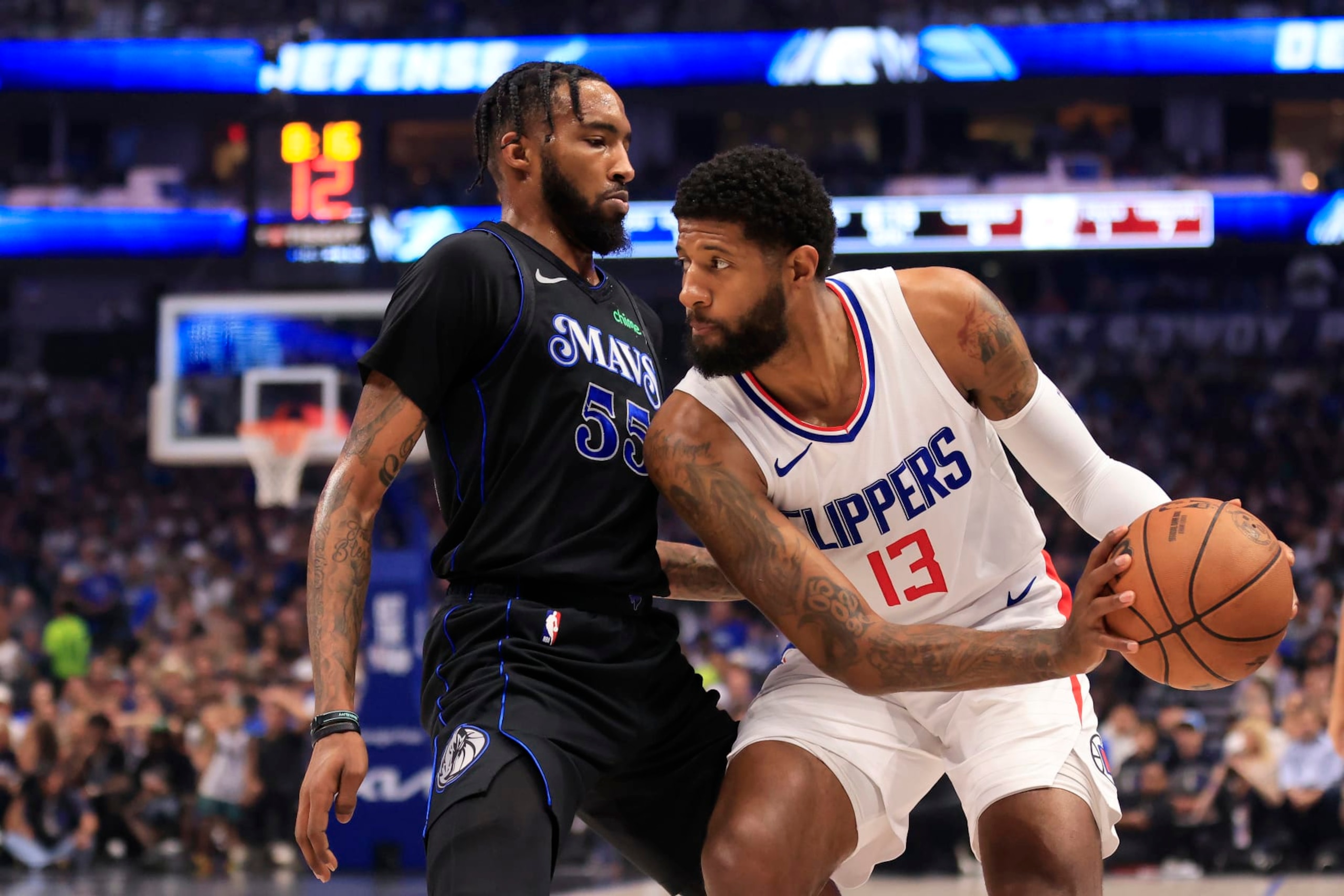 DALLAS, TEXAS - MAY 03: Paul George #13 of the LA Clippers drives the ball against Derrick Jones Jr. #55 of the Dallas Mavericks during the first quarter in Game Six of the Western Conference First Round Playoffs at American Airlines Center on May 03, 2024 in Dallas, Texas.  (Photo by Ron Jenkins/Getty Images)