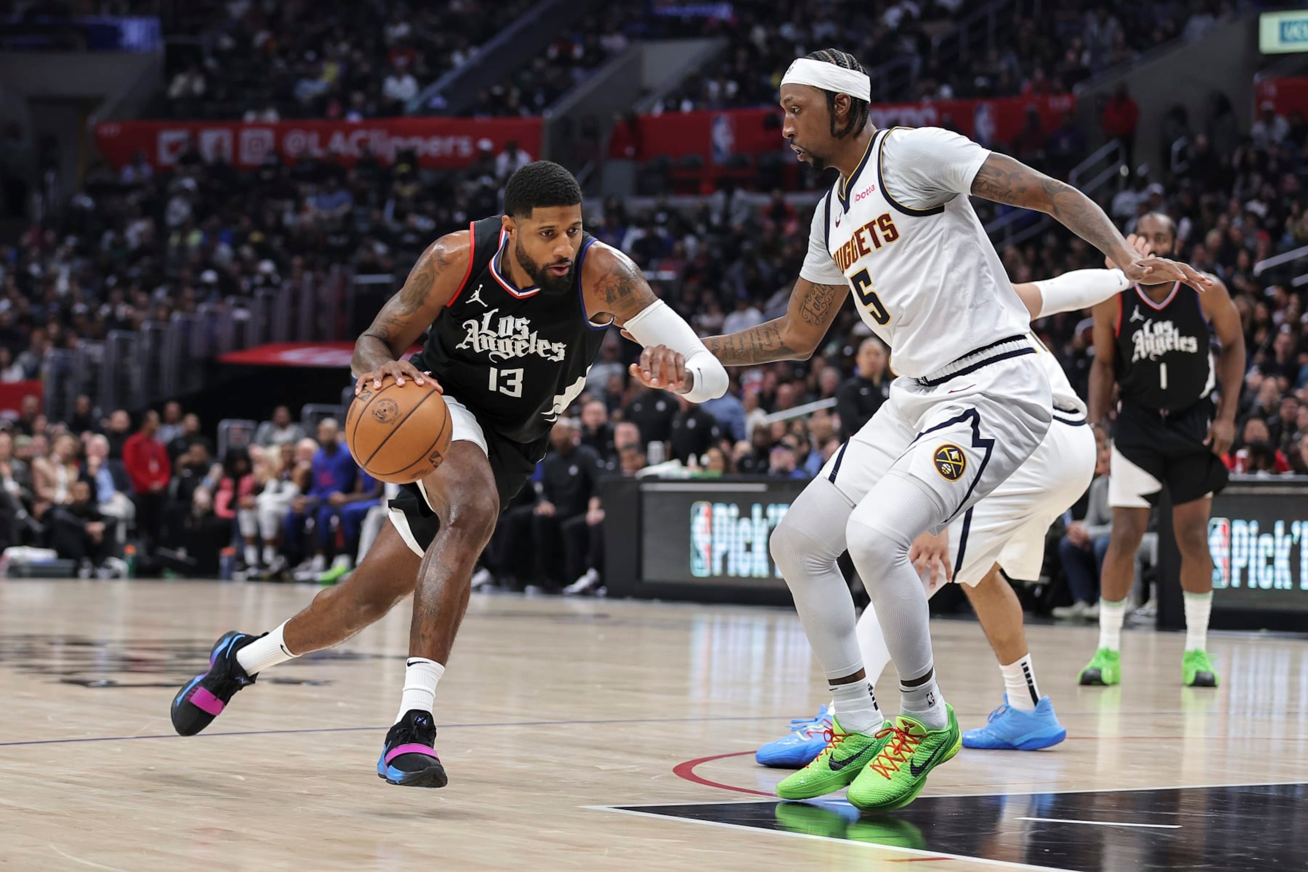 LOS ANGELES, CALIFORNIA - DECEMBER 06: Paul George #13 of the LA Clippers drives against Kentavious Caldwell-Pope #5 of the Denver Nuggets during the second half a game at Crypto.com Arena on December 06, 2023 in Los Angeles, California. NOTE TO USER: User expressly acknowledges and agrees that, by downloading and or using this photograph, User is consenting to the terms and conditions of the Getty Images License Agreement. (Photo by Michael Owens/Getty Images) LOS ANGELES, CALIFORNIA - DECEMBER 06: Paul George #13 of the LA Clippers drives against Kentavious Caldwell-Pope #5 of the Denver Nuggets during the second half a game at Crypto.com Arena on December 06, 2023 in Los Angeles, California. NOTE TO USER: User expressly acknowledges and agrees that, by downloading and or using this photograph, User is consenting to the terms and conditions of the Getty Images License Agreement. (Photo by Michael Owens/Getty Images)