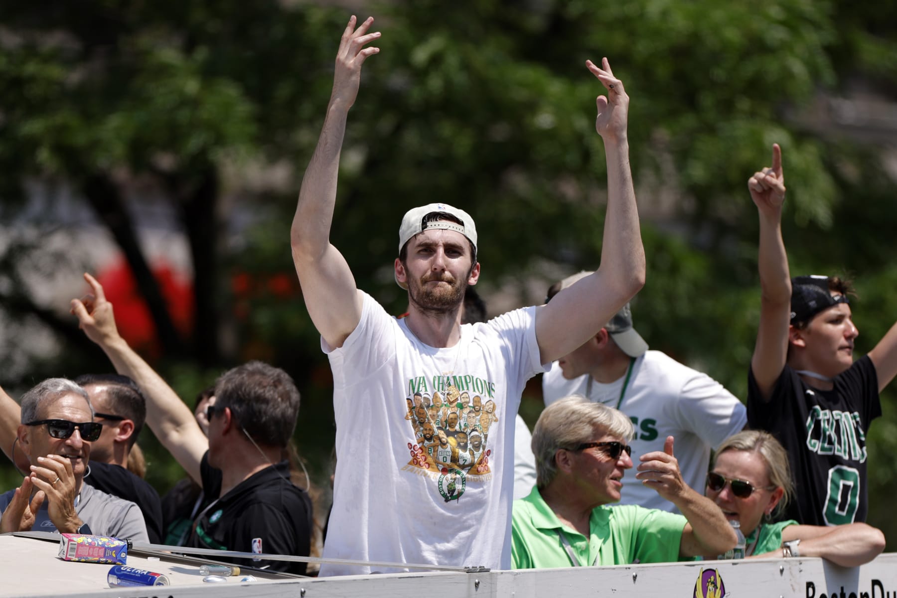 Boston, MA - June 21: Boston Celtics center Luke Kornet waves to the crowd at Copley Square during a duck boat parade to celebrate the 18th Boston Celtics NBA championship. (Photo by Danielle Parhizkaran/The Boston Globe via Getty Images)