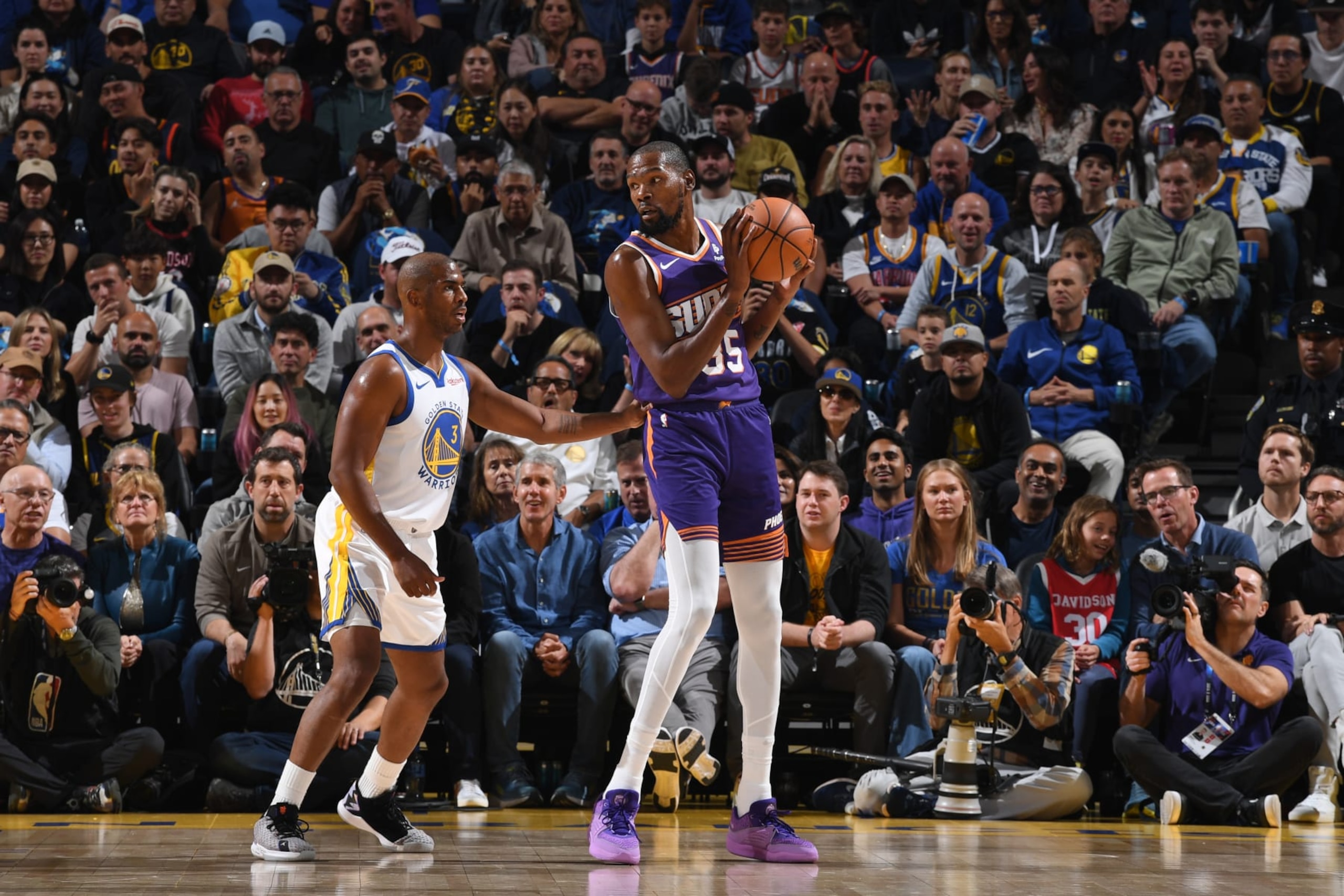 SAN FRANCISCO, CA - OCTOBER 24: Kevin Durant #35 of the Phoenix Suns handles the ball against Chris Paul #3 of the Golden State Warriors during the game on October 24, 2023 at Chase Center in San Francisco, California. NOTE TO USER: User expressly acknowledges and agrees that, by downloading and or using this photograph, user is consenting to the terms and conditions of Getty Images License Agreement. Mandatory Copyright Notice: Copyright 2023 NBAE (Photo by Noah Graham/NBAE via Getty Images)