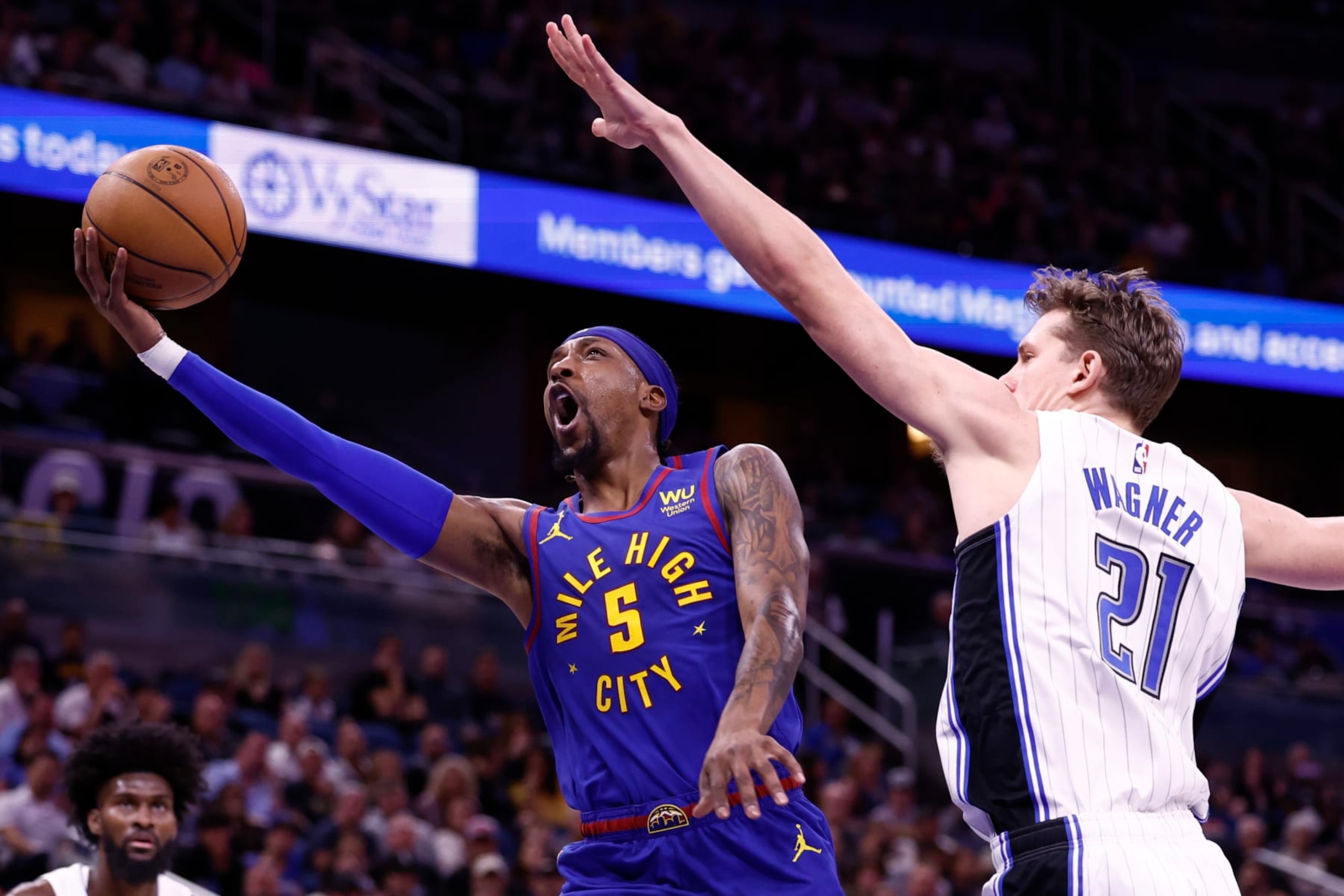 ORLANDO, FLORIDA - FEBRUARY 09: Kentavious Caldwell-Pope #5 of the Denver Nuggets drives to the net as Moritz Wagner #21 of the Orlando Magic defends during the first quarter at Amway Center on February 09, 2023 in Orlando, Florida. NOTE TO USER: User expressly acknowledges and agrees that, by downloading and or using this photograph, User is consenting to the terms and conditions of the Getty Images License Agreement. (Photo by Douglas P. DeFelice/Getty Images)