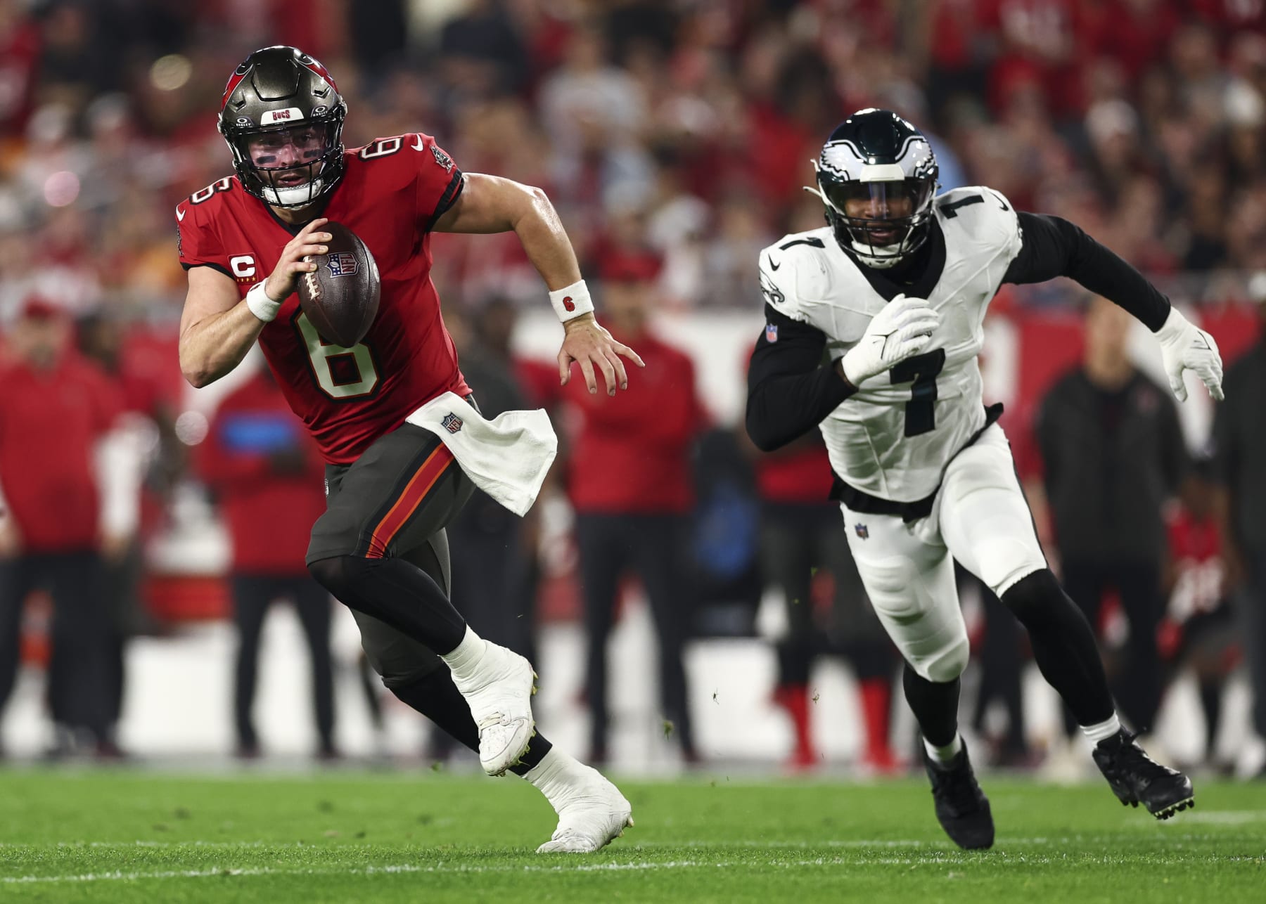 TAMPA, FL - JANUARY 15: Baker Mayfield #6 of the Tampa Bay Buccaneers carries the ball as Haason Reddick #7 of the Philadelphia Eagles chases during an NFL wild-card playoff football game at Raymond James Stadium on January 15, 2024 in Tampa, Florida. (Photo by Kevin Sabitus/Getty Images)