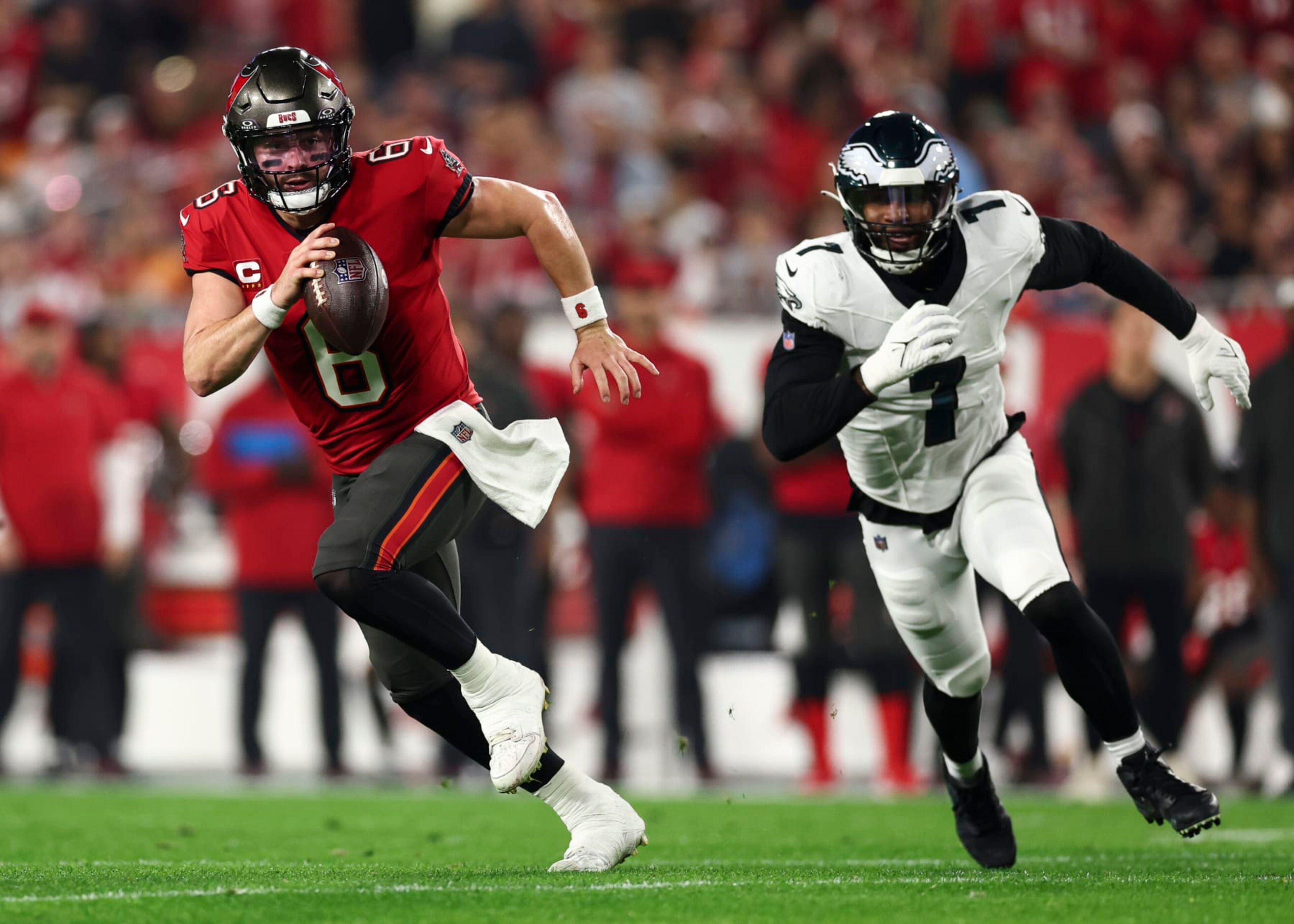 TAMPA, FL - JANUARY 15: Baker Mayfield #6 of the Tampa Bay Buccaneers carries the ball as Haason Reddick #7 of the Philadelphia Eagles chases during an NFL wild-card playoff football game at Raymond James Stadium on January 15, 2024 in Tampa, Florida. (Photo by Kevin Sabitus/Getty Images)