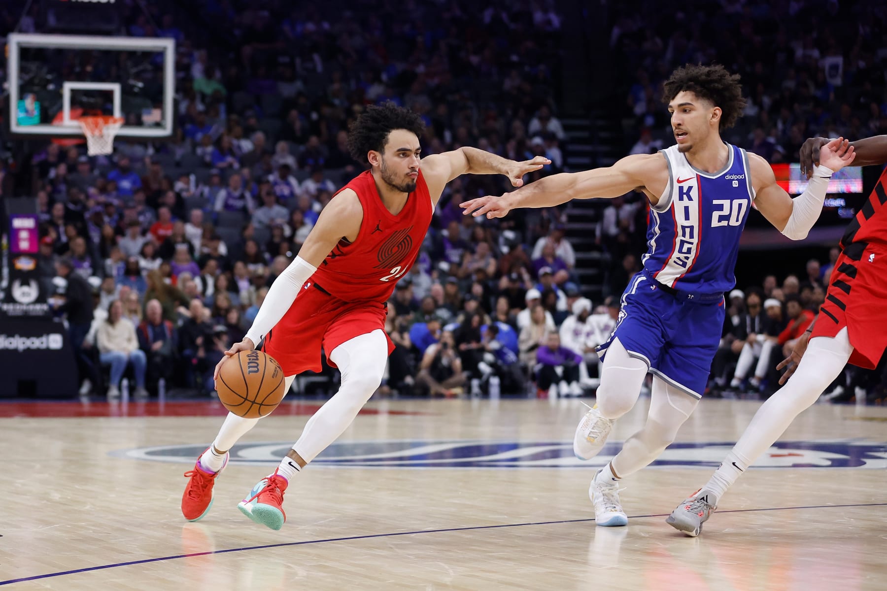 SACRAMENTO, CALIFORNIA - APRIL 14: Justin Minaya #24 of the Portland Trail Blazers drives to the basket against Colby Jones #20 of the Sacramento Kings in the fourth quarter at Golden 1 Center on April 14, 2024 in Sacramento, California. NOTE TO USER: User expressly acknowledges and agrees that, by downloading and or using this photograph, User is consenting to the terms and conditions of the Getty Images License Agreement. (Photo by Lachlan Cunningham/Getty Images)