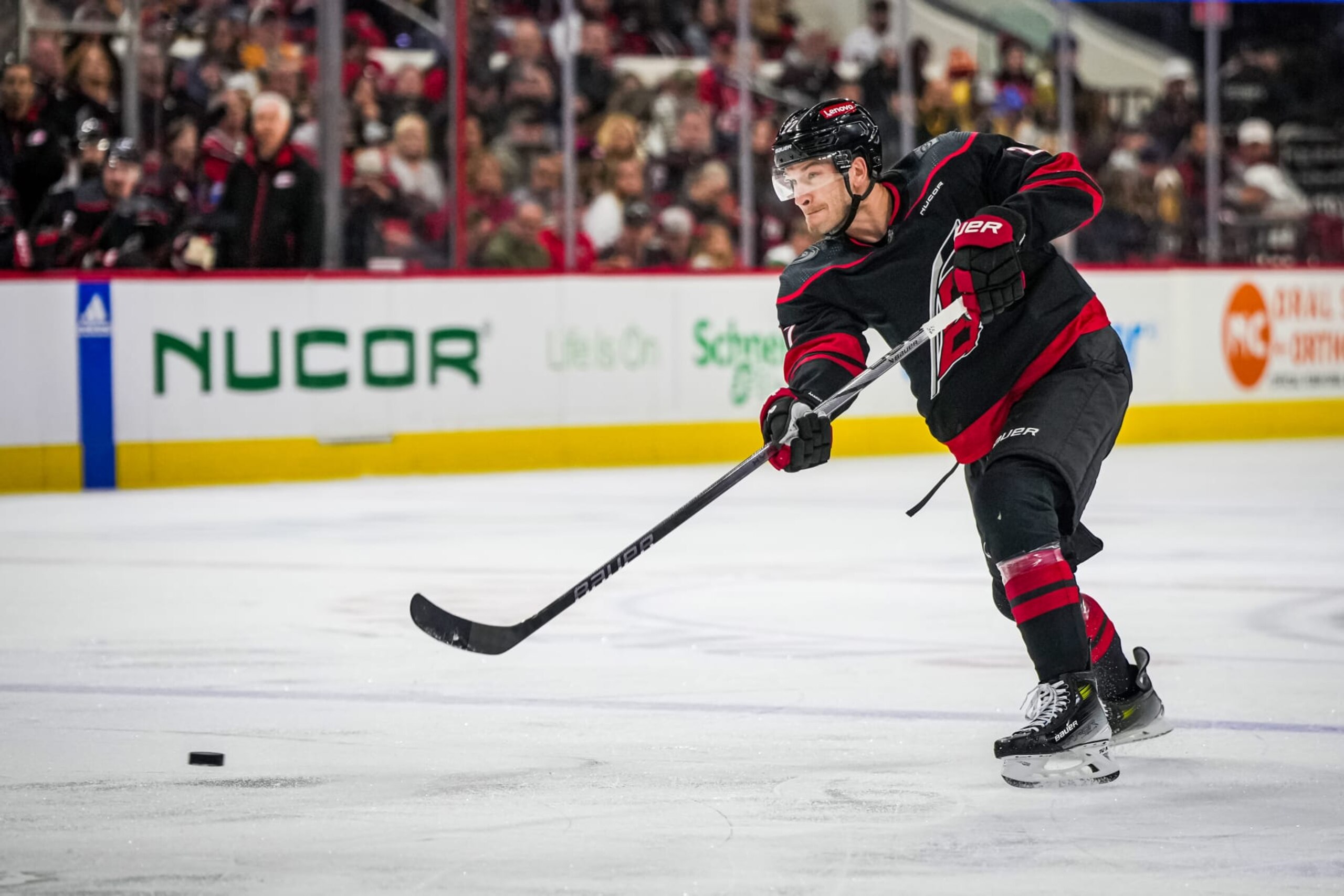 RALEIGH, NORTH CAROLINA - APRIL 04:  Brett Pesce #22 of the Carolina Hurricanes shoots the puck during the first period against the Boston Bruins at PNC Arena on April 4, 2024 in Raleigh, North Carolina. (Photo by Josh Lavallee/NHLI via Getty Images)