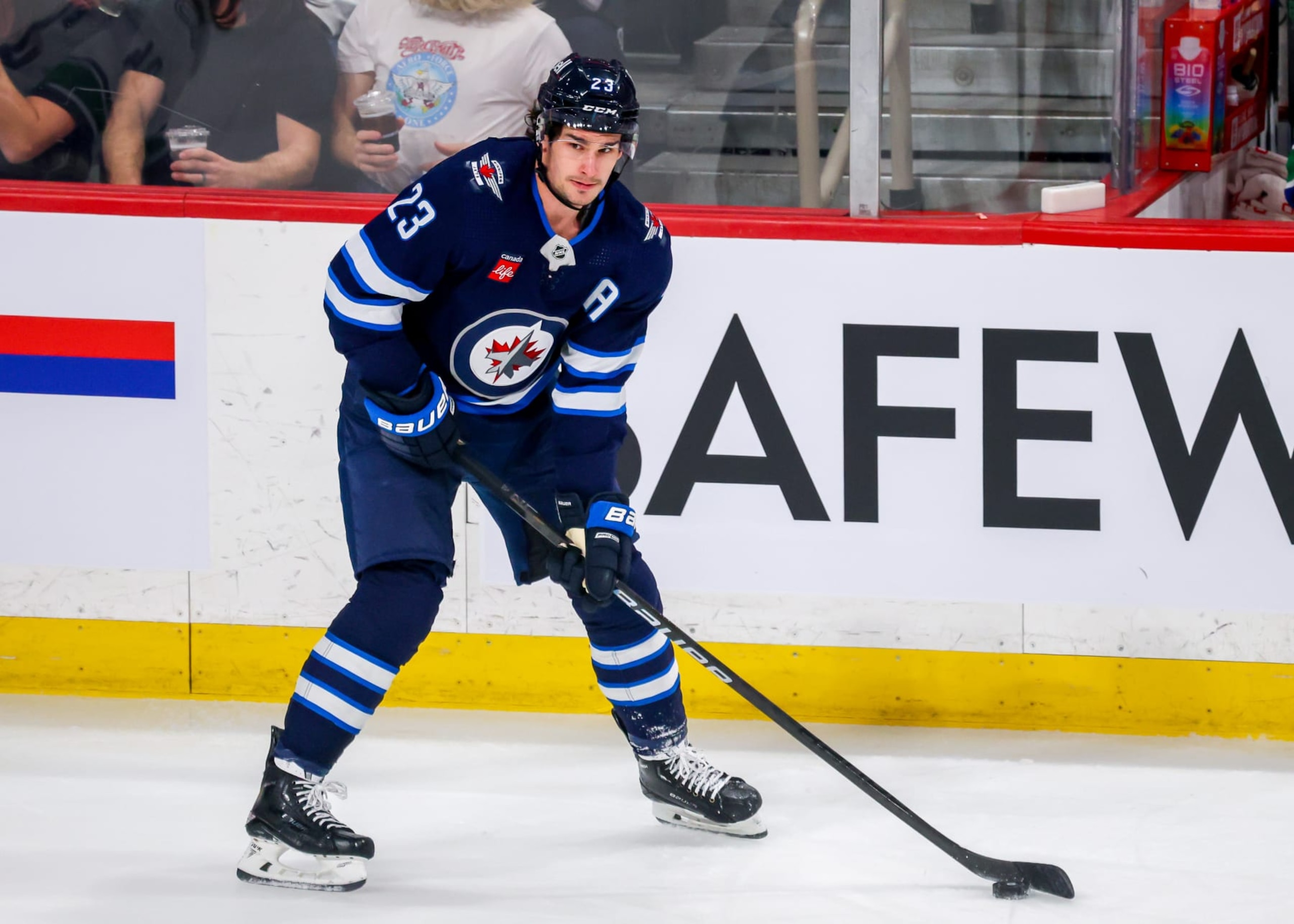WINNIPEG, CANADA - APRIL 18: Sean Monahan #23 of the Winnipeg Jets plays the puck during first period action against the Vancouver Canucks at Canada Life Centre on April 18, 2024 in Winnipeg, Manitoba, Canada. (Photo by Jonathan Kozub/NHLI via Getty Images)