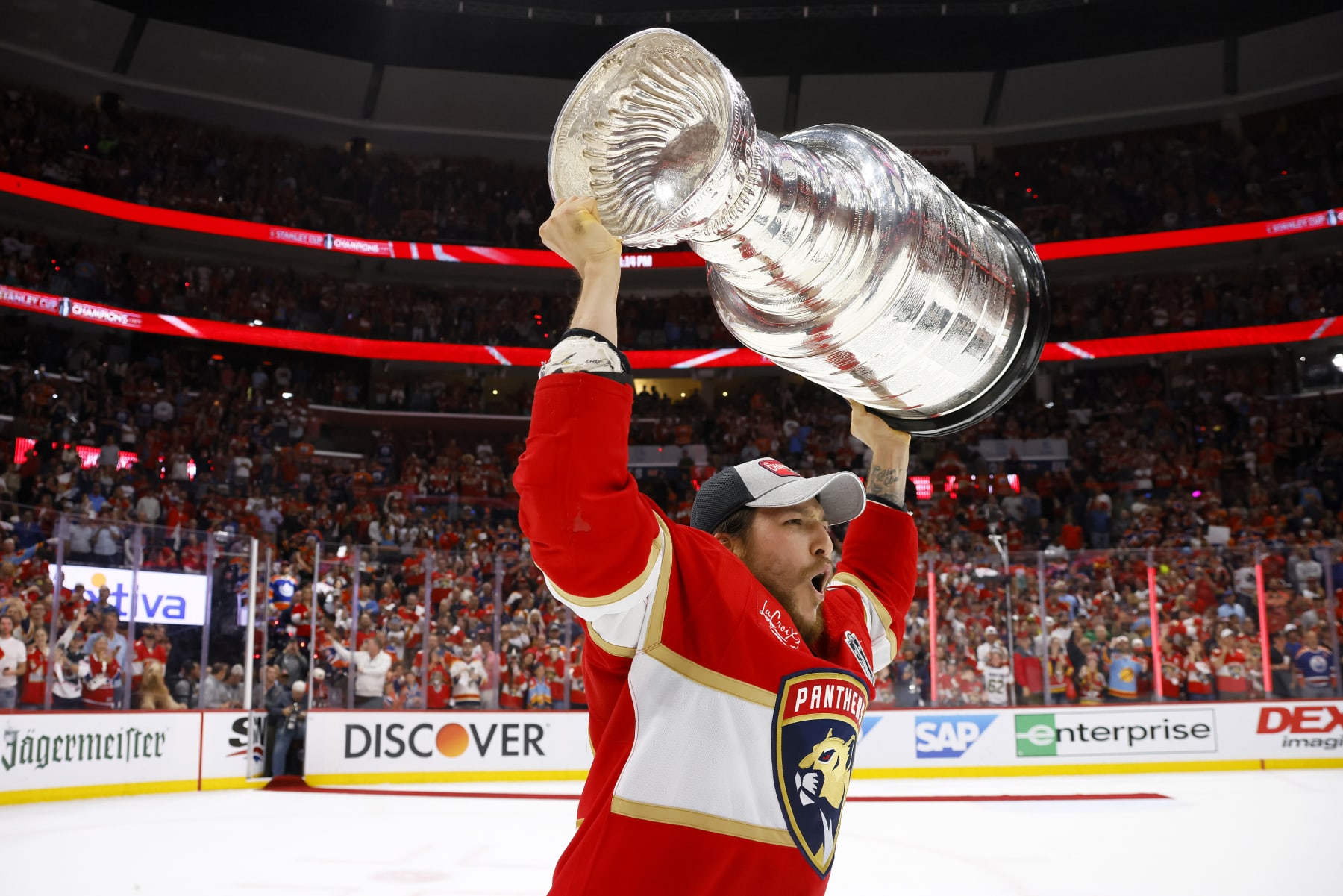 SUNRISE, FLORIDA - JUNE 24: Brandon Montour #62 of the Florida Panthers yells while lifting the Stanley Cup after Florida's 2-1 victory against the Edmonton Oilers in Game Seven of the 2024 Stanley Cup Final at Amerant Bank Arena on June 24, 2024 in Sunrise, Florida. (Photo by Bruce Bennett/Getty Images)