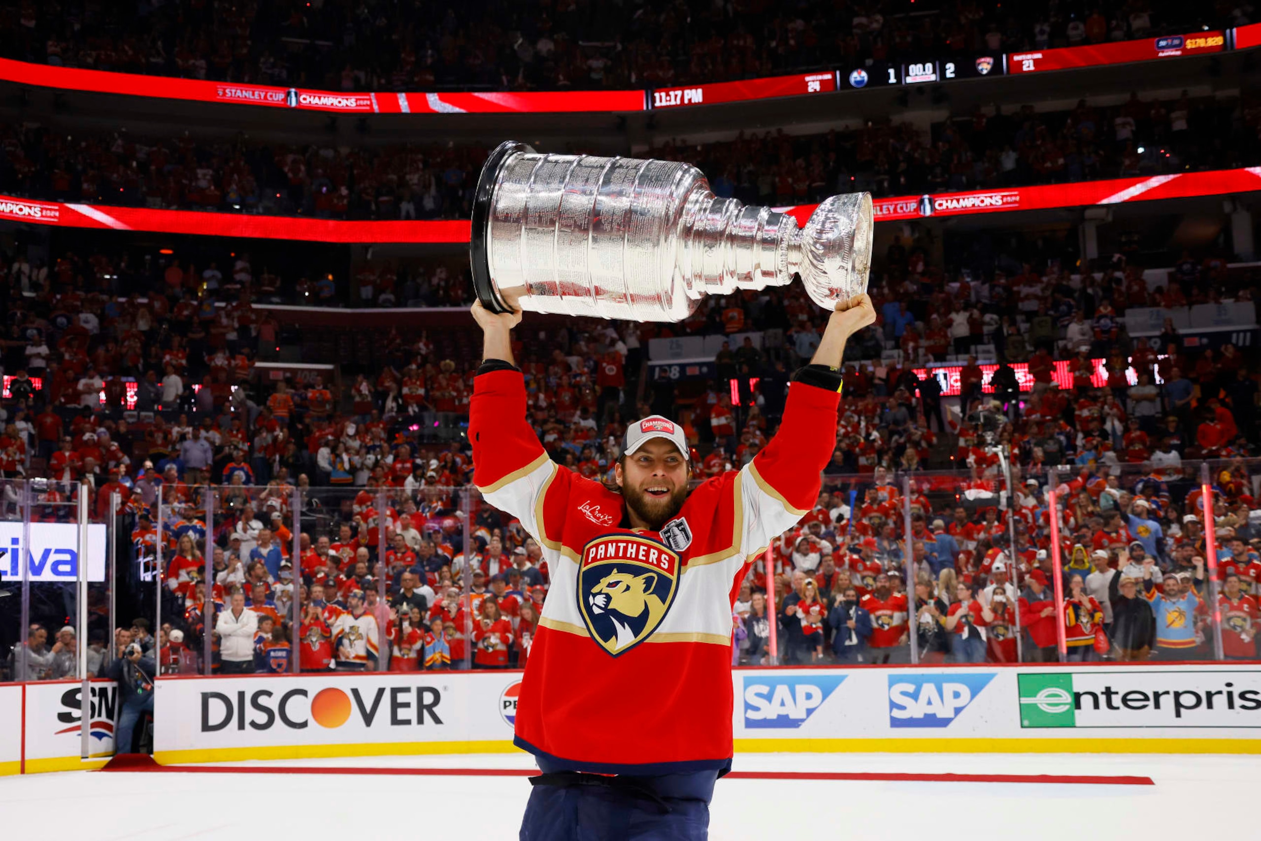 SUNRISE, FLORIDA - JUNE 24: Kevin Stenlund #82 of the Florida Panthers hoists the Stanley Cup after Florida's 2-1 victory against the Edmonton Oilers in Game Seven of the 2024 Stanley Cup Final at Amerant Bank Arena on June 24, 2024 in Sunrise, Florida. (Photo by Bruce Bennett/Getty Images)