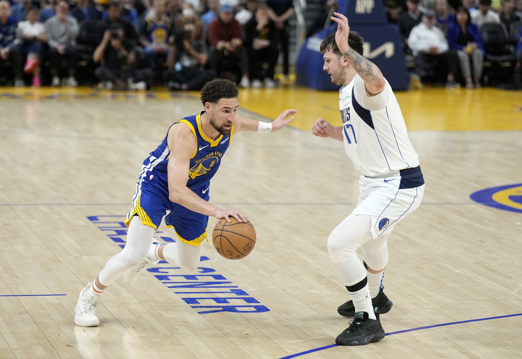 SAN FRANCISCO, CALIFORNIA - APRIL 02: Klay Thompson #11 of the Golden State Warriors dribbling the ball is guarded by Luka Doncic #77 of the Dallas Mavericks during the second half at Chase Center on April 02, 2024 in San Francisco, California. NOTE TO USER: User expressly acknowledges and agrees that, by downloading and or using this photograph, User is consenting to the terms and conditions of the Getty Images License Agreement. (Photo by Thearon W. Henderson/Getty Images)