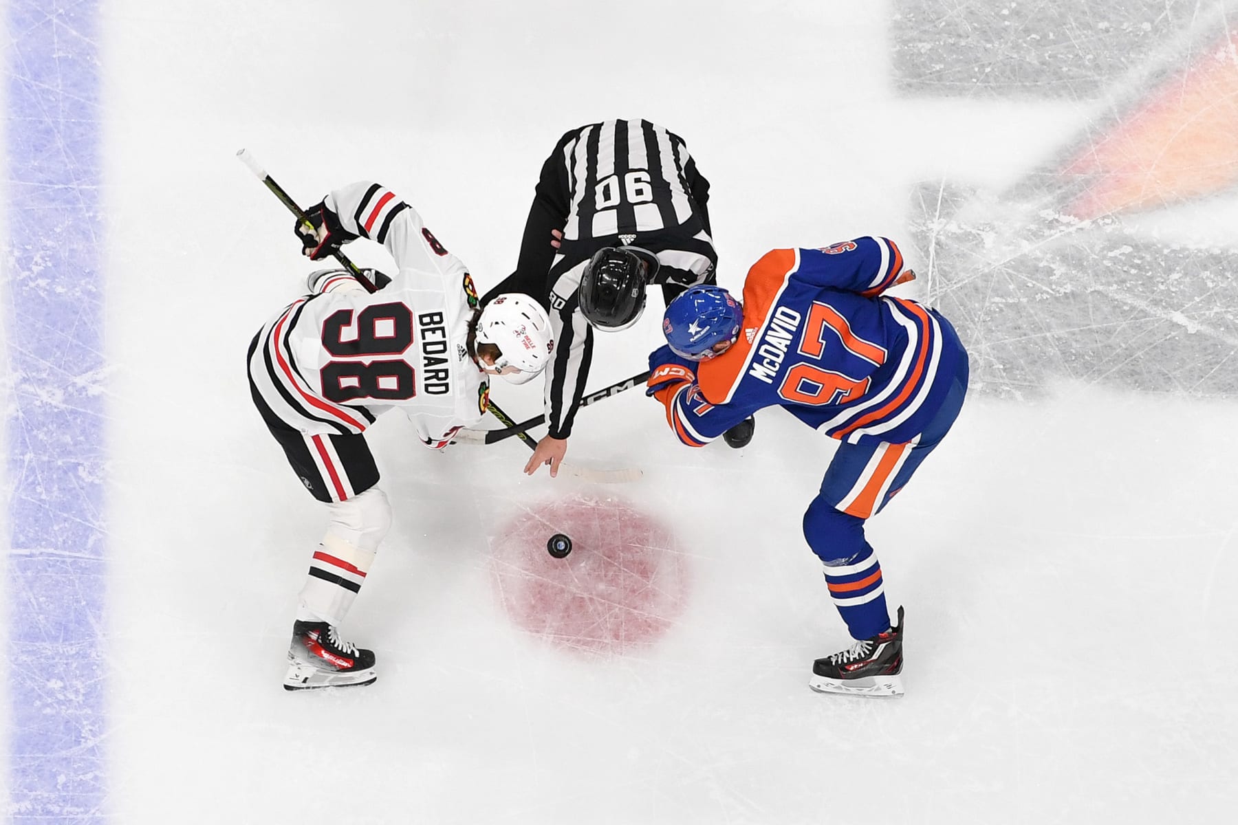 EDMONTON, CANADA - DECEMBER 12: Connor McDavid #97 of the Edmonton Oilers takes a face-off against Connor Bedard #98 of the Chicago Blackhawks during the game at Rogers Place on December 12, 2023, in Edmonton, Alberta, Canada. (Photo by Andy Devlin/NHLI via Getty Images)