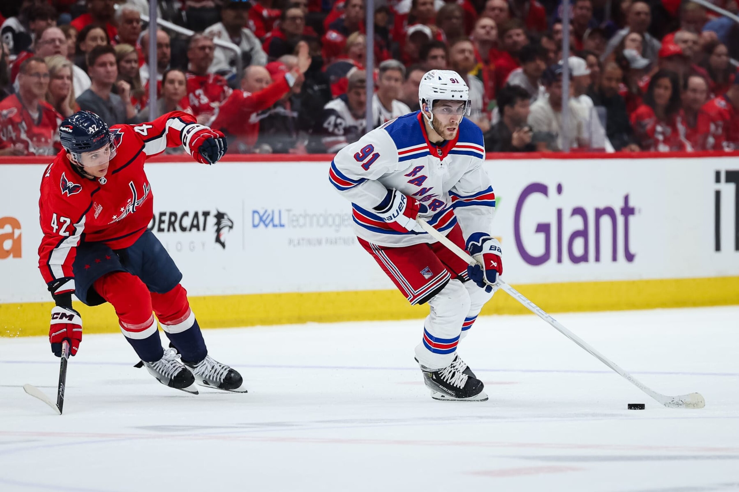 WASHINGTON, DC - APRIL 28: Alex Wennberg #91 of the New York Rangers skates with the puck in front of Martin Fehervary #42 of the Washington Capitals during the third period in Game Four of the First Round of the 2024 Stanley Cup Playoffs at Capital One Arena on April 28, 2024 in Washington, DC. (Photo by Scott Taetsch/Getty Images)