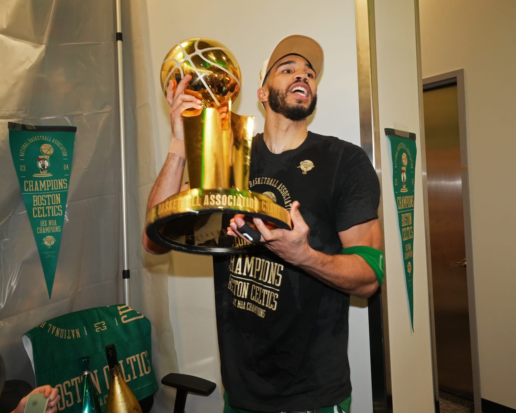 BOSTON, MA - JUNE 17: Jayson Tatum #0 of the Boston Celtics celebrates with the Larry O'Brien Trophy after the game against the Dallas Mavericks during Game 5 of the 2024 NBA Finals on June 17, 2024 at the TD Garden in Boston, Massachusetts. NOTE TO USER: User expressly acknowledges and agrees that, by downloading and or using this photograph, User is consenting to the terms and conditions of the Getty Images License Agreement. Mandatory Copyright Notice: Copyright 2024 NBAE  (Photo by Jesse D. Garrabrant/NBAE via Getty Images)
