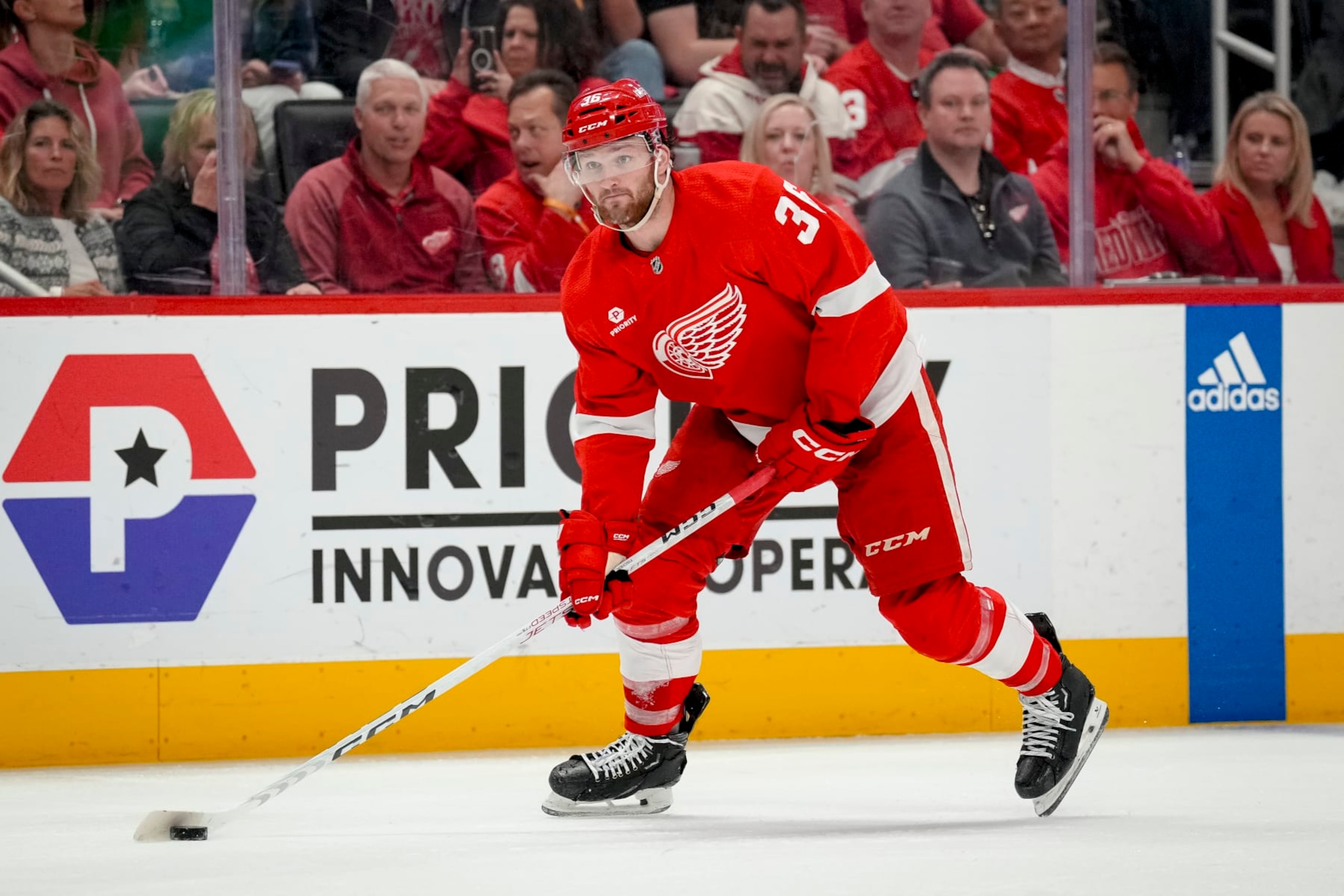 DETROIT, MICHIGAN - APRIL 09: Christian Fischer #36 of the Detroit Red Wings handles the puck against the Washington Capitals at Little Caesars Arena on April 09, 2024 in Detroit, Michigan. (Photo by Nic Antaya/Getty Images)