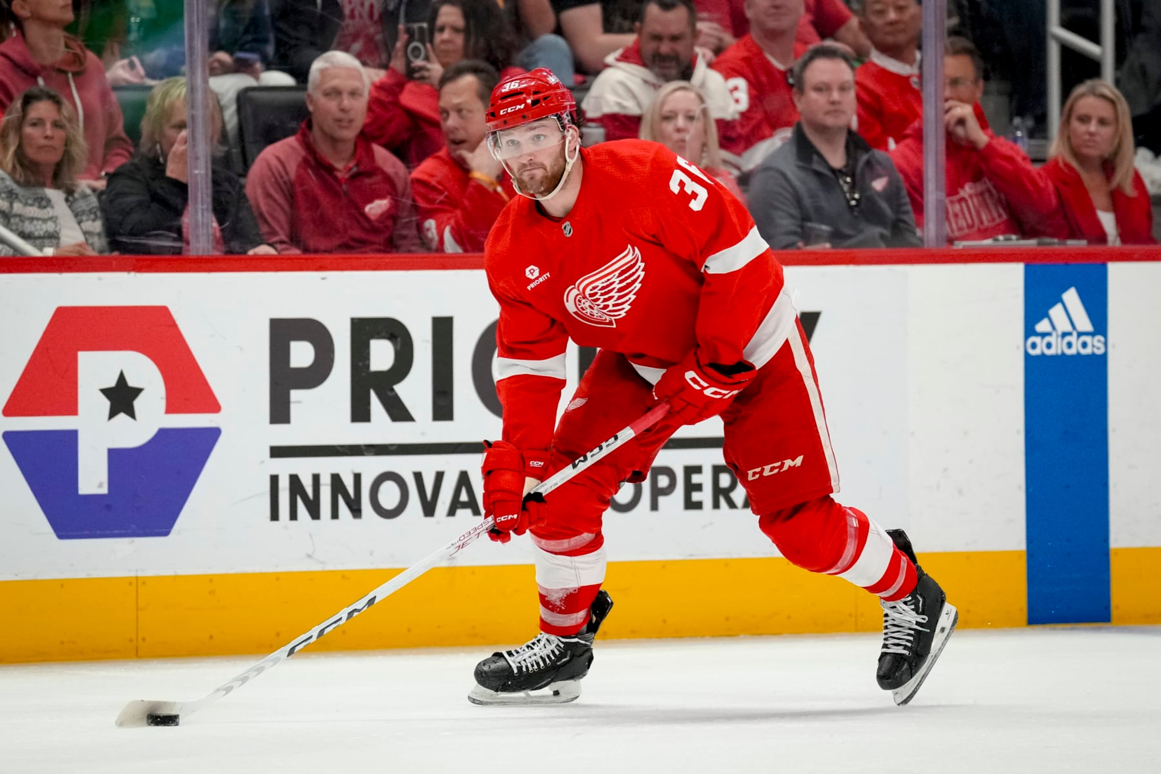 DETROIT, MICHIGAN - APRIL 09: Christian Fischer #36 of the Detroit Red Wings handles the puck against the Washington Capitals at Little Caesars Arena on April 09, 2024 in Detroit, Michigan. (Photo by Nic Antaya/Getty Images)