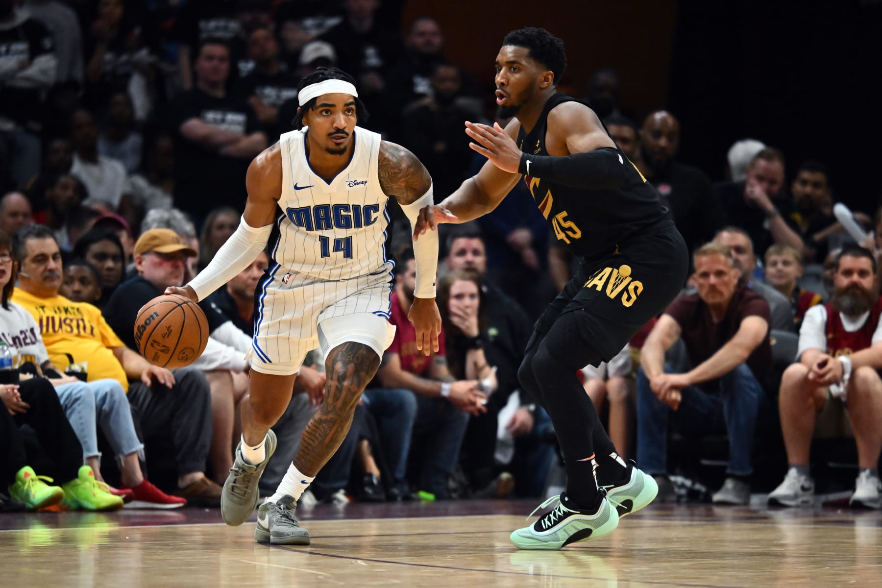 CLEVELAND, OHIO - MAY 05: Gary Harris #14 of the Orlando Magic drives around Donovan Mitchell #45 of the Cleveland Cavaliers during the fourth quarter of Game Seven of the Eastern Conference First Round Playoffs at Rocket Mortgage Fieldhouse on May 05, 2024 in Cleveland, Ohio. The Cavaliers defeated the Magic 106-94. NOTE TO USER: User expressly acknowledges and agrees that, by downloading and/or using this Photograph, user is consenting to the terms and conditions of the Getty Images License Agreement. (Photo by Jason Miller/Getty Images)