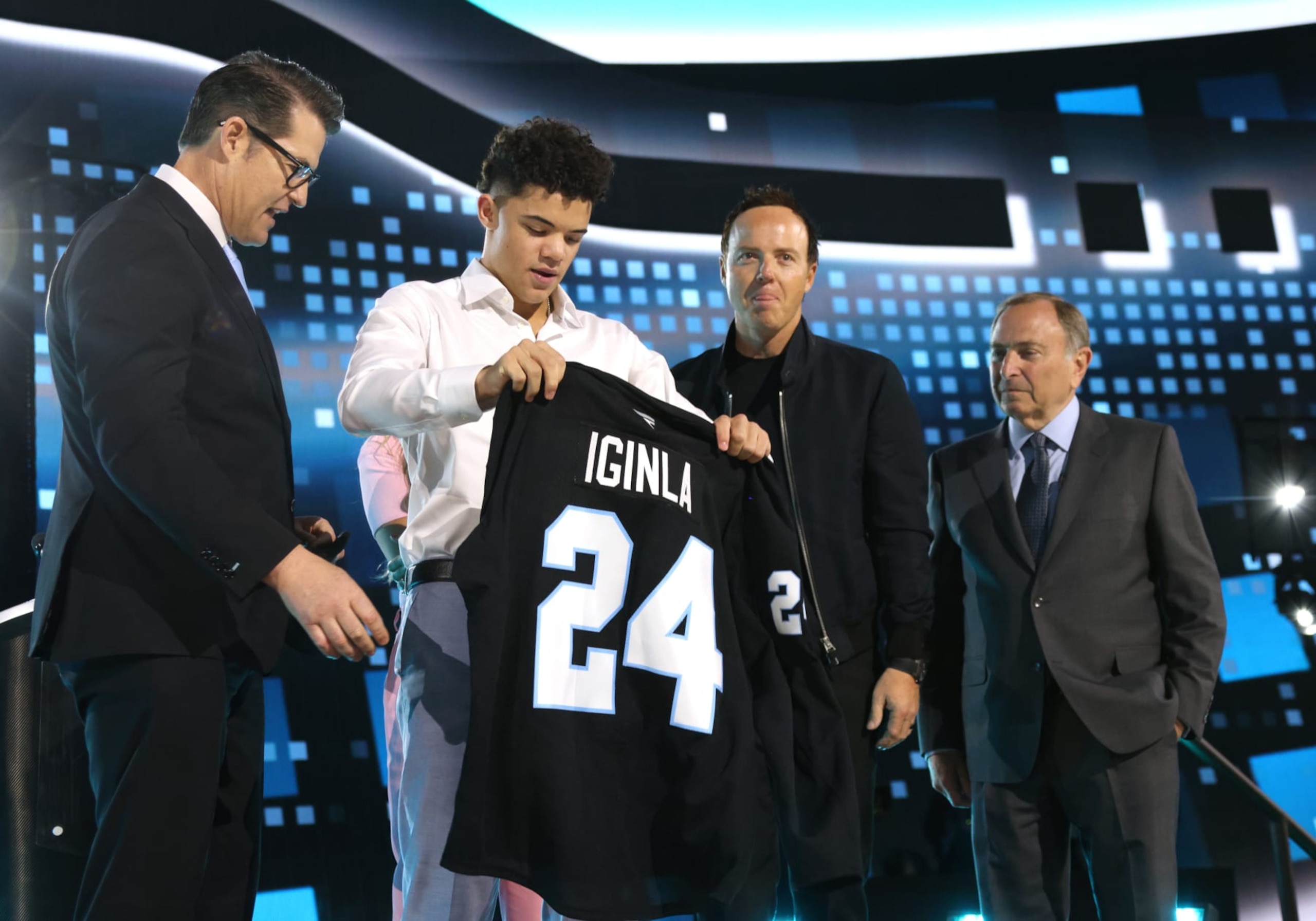 LAS VEGAS, NEVADA - JUNE 28: Tij Iginla puts on a jersey after being selected sixth overall by Utah Hockey Club during the first round of the 2024 Upper Deck NHL Draft at Sphere on June 28, 2024 in Las Vegas, Nevada. (Photo by Dave Sandford/NHLI via Getty Images) LAS VEGAS, NEVADA - JUNE 28: Tij Iginla puts on a jersey after being selected sixth overall by Utah Hockey Club during the first round of the 2024 Upper Deck NHL Draft at Sphere on June 28, 2024 in Las Vegas, Nevada. (Photo by Dave Sandford/NHLI via Getty Images)