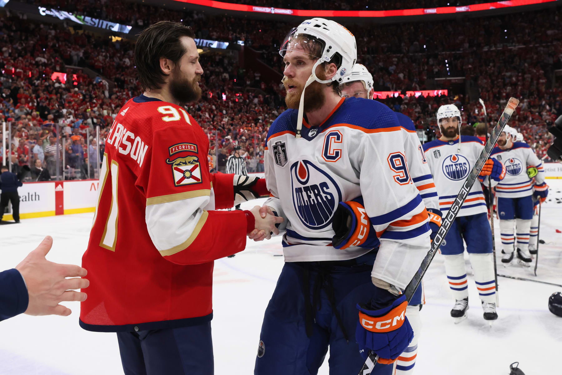 SUNRISE, FLORIDA - JUNE 24: Oliver Ekman-Larsson #91 of the Florida Panthers shakes hands with Connor McDavid #97 of the Edmonton Oilers after Florida's 2-1 victory in Game Seven of the 2024 Stanley Cup Final at Amerant Bank Arena on June 24, 2024 in Sunrise, Florida. (Photo by Bruce Bennett/Getty Images)