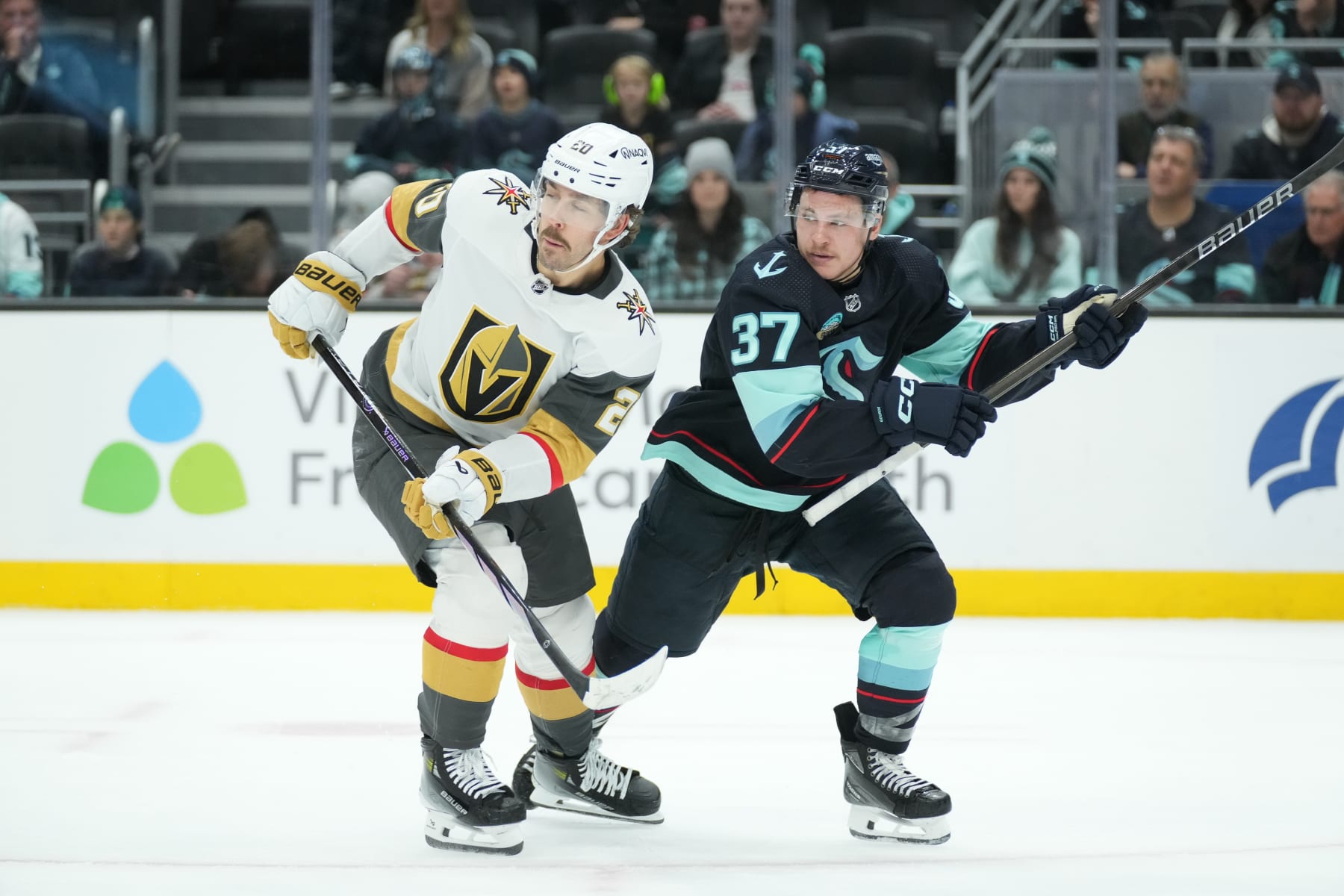 SEATTLE, WA - MARCH 12: Vegas Golden Knights center Chandler Stephenson (20) and Seattle Kraken center Yanni Gourde (37) look down the ice during an NHL game between the Seattle Kraken and the Vegas Golden Knights on March 12, 2024 at Climate Pledge Arena in Seattle, WA. (Photo by Jeff Halstead/Icon Sportswire via Getty Images)