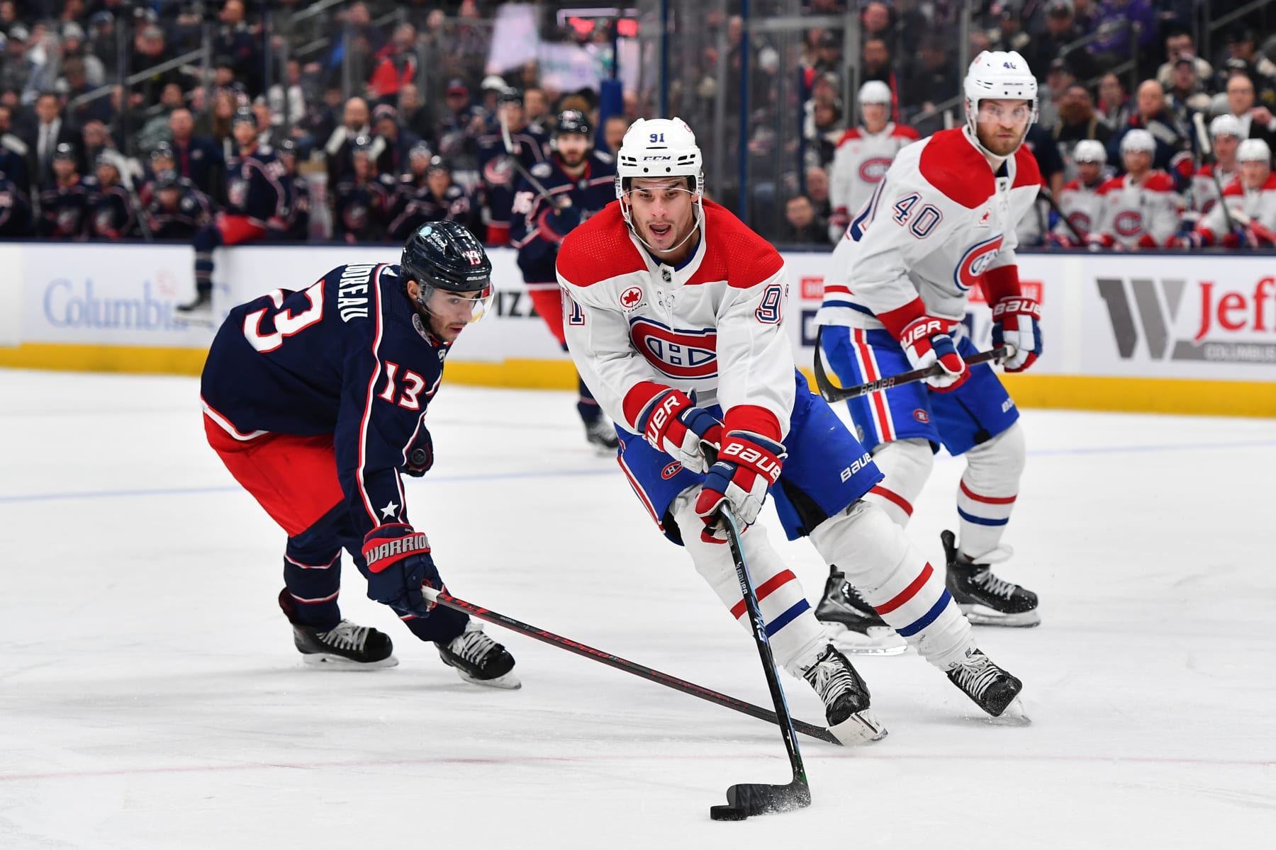 COLUMBUS, OHIO - NOVEMBER 29: Sean Monahan #91 of the Montreal Canadiens battles to keep the puck from Johnny Gaudreau #13 of the Columbus Blue Jackets during the second period of a game at Nationwide Arena on November 29, 2023 in Columbus, Ohio. (Photo by Ben Jackson/NHLI via Getty Images)