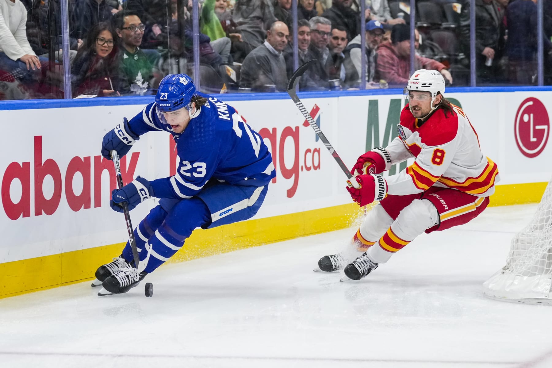 TORONTO, ON - NOVEMBER 10: Matthew Knies #23 of the Toronto Maple Leafs plays the puck against Chris Tanev #8 of the Calgary Flames during the second period at the Scotiabank Arena on November 10, 2023 in Toronto, Ontario, Canada. (Photo by Kevin Sousa/NHLI via Getty Images)