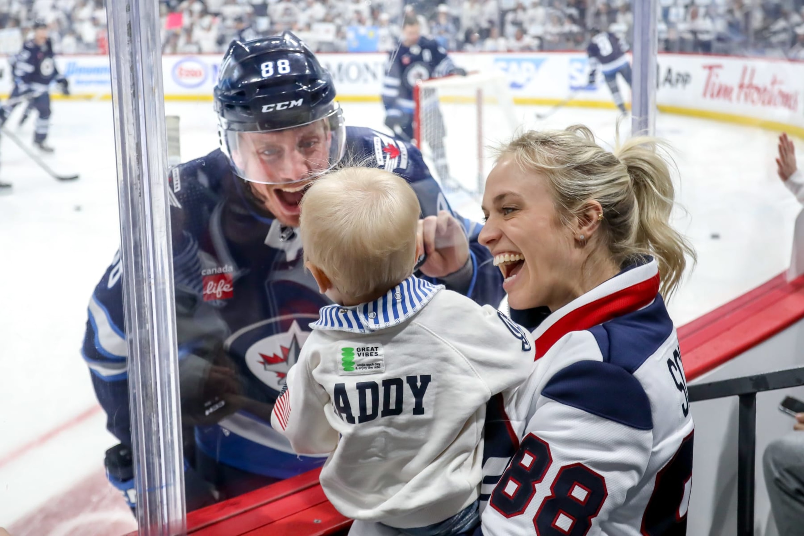 WINNIPEG, CANADA - APRIL 30: Nate Schmidt #88 of the Winnipeg Jets shares a moment with wife, Allie and son, Harvey during the pre-game warm up prior to NHL action against the Colorado Avalanche in Game Five of the First Round of the 2024 Stanley Cup Playoffs at the Canada Life Centre on April 30, 2024 in Winnipeg, Manitoba, Canada. (Photo by Darcy Finley/NHLI via Getty Images)