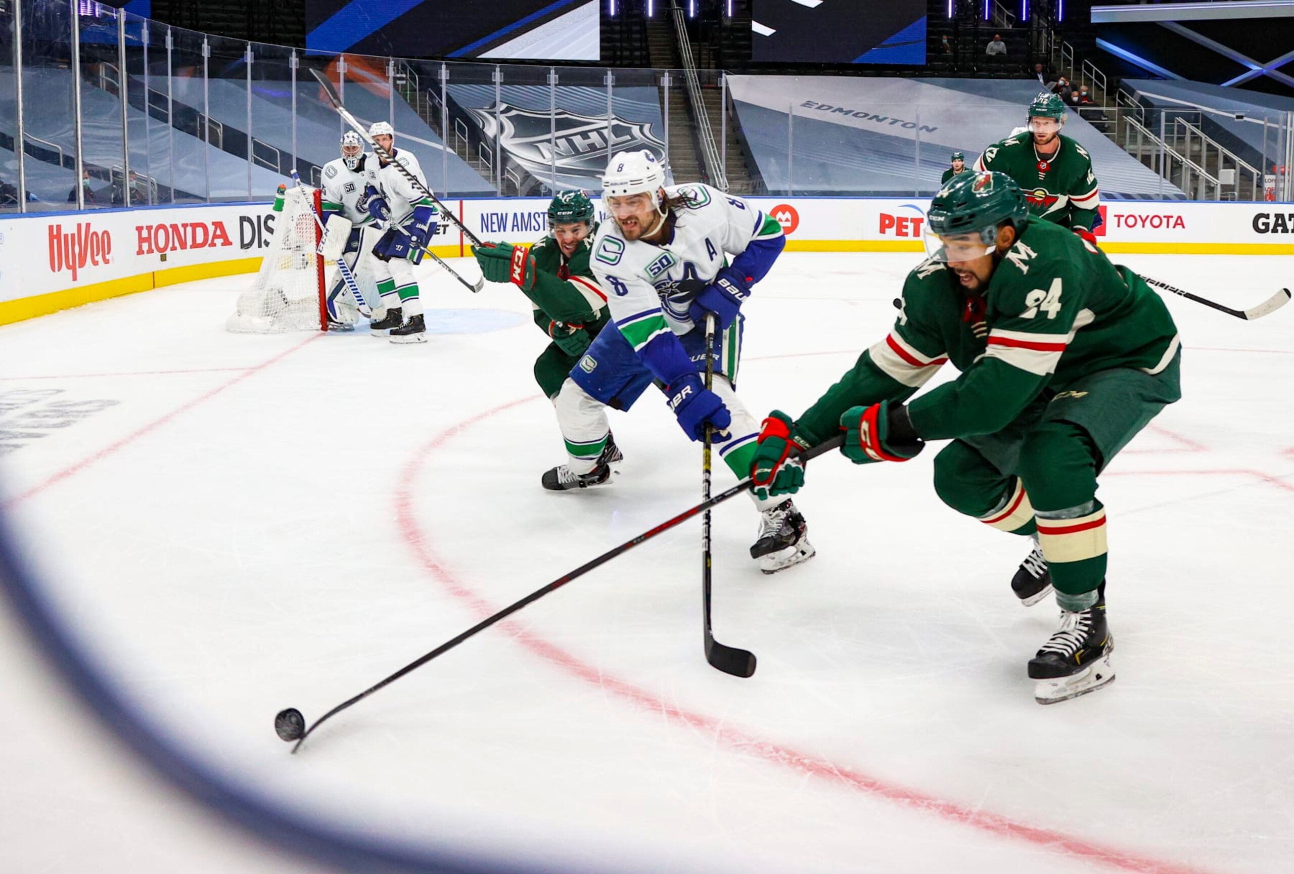 EDMONTON, ALBERTA - AUGUST 06: Matt Dumba #24 of the Minnesota Wild battles for the puck against Chris Tanev #8 of the Vancouver Canucks during the third in Game Three of the Western Conference Qualification Round at Rogers Place on August 06, 2020 in Edmonton, Alberta. (Photo by Dave Sandford/NHLI via Getty Images) EDMONTON, ALBERTA - AUGUST 06: Matt Dumba #24 of the Minnesota Wild battles for the puck against Chris Tanev #8 of the Vancouver Canucks during the third in Game Three of the Western Conference Qualification Round at Rogers Place on August 06, 2020 in Edmonton, Alberta. (Photo by Dave Sandford/NHLI via Getty Images)