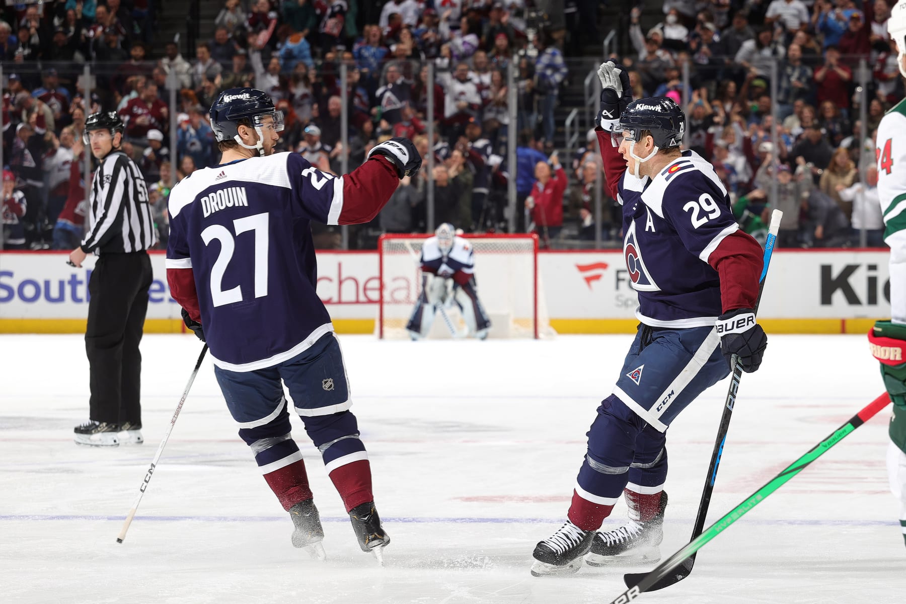 DENVER, COLORADO - APRIL 09: Jonathan Drouin #27 and Nathan MacKinnon #29 of the Colorado Avalanche celebrate a goal against the Minnesota Wild at Ball Arena on April 9, 2024 in Denver, Colorado. (Photo by Michael Martin/NHLI via Getty Images)