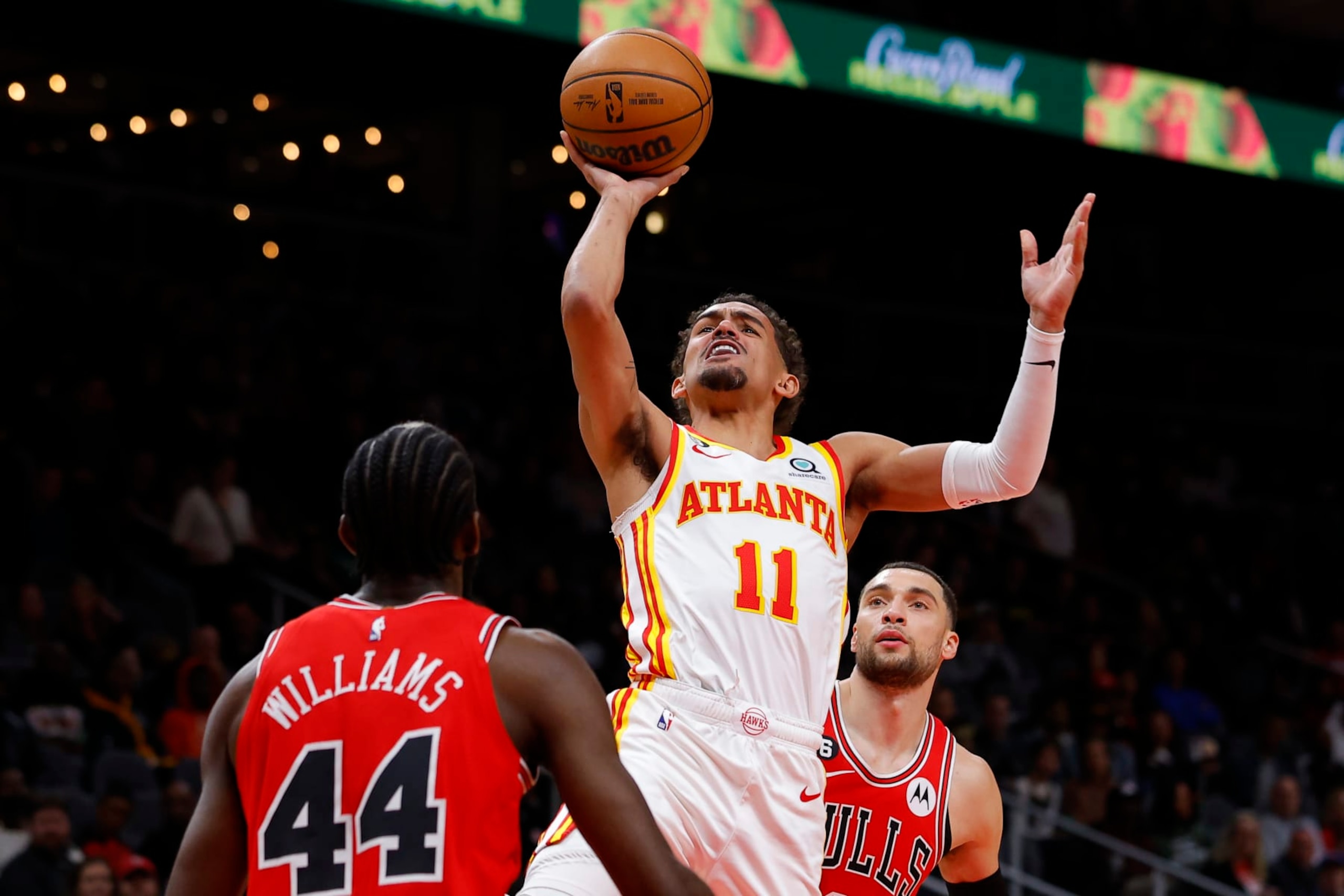 ATLANTA, GA - DECEMBER 11: Trae Young #11 of the Atlanta Hawks shoots as he is fouled by Zach LaVine #8 of the Chicago Bulls during the first half of the game at State Farm Arena on December 11, 2022 in Atlanta, Georgia. NOTE TO USER: User expressly acknowledges and agrees that, by downloading and or using this photograph, User is consenting to the terms and conditions of the Getty Images License Agreement. (Photo by Todd Kirkland/Getty Images)