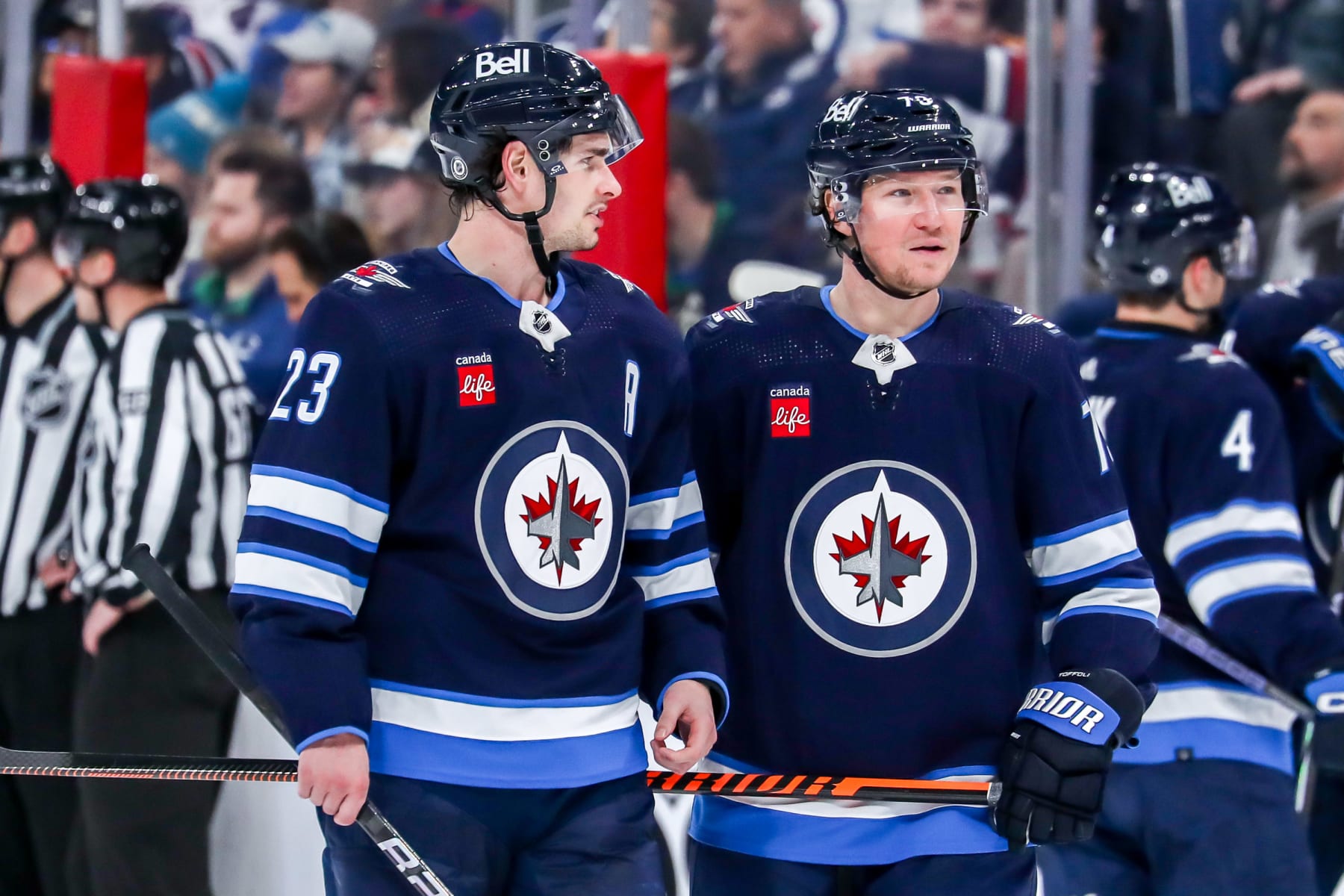 WINNIPEG, CANADA - APRIL 18: Sean Monahan #23 and Tyler Toffoli #73 of the Winnipeg Jets discuss strategy during a second period stoppage in play against the Vancouver Canucks at the Canada Life Centre on April 18, 2024 in Winnipeg, Manitoba, Canada. (Photo by Darcy Finley/NHLI via Getty Images)