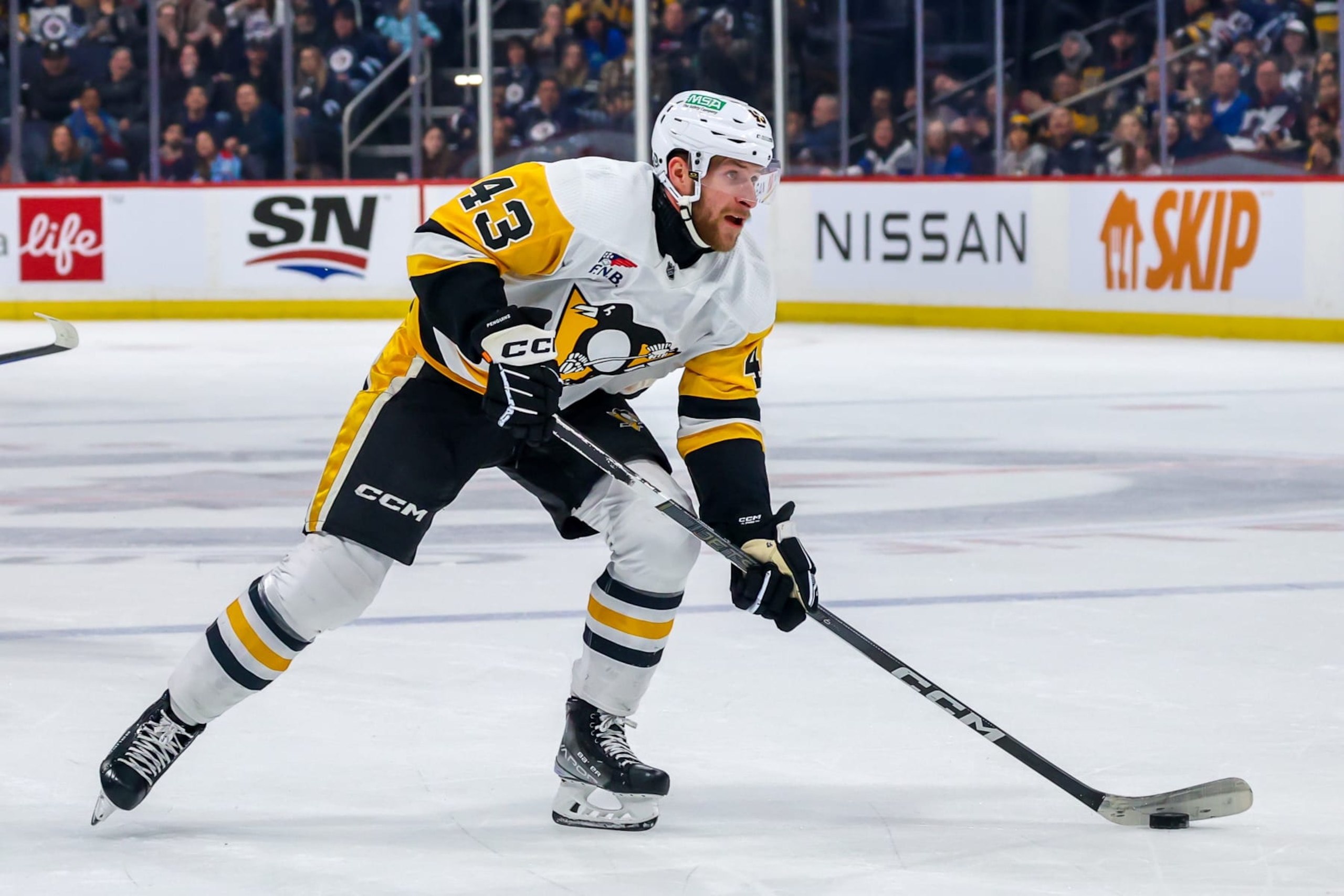 WINNIPEG, CANADA - FEBRUARY 10: Jansen Harkins #43 of the Pittsburgh Penguins plays the puck during first period action against the Winnipeg Jets at Canada Life Centre on February 10, 2024 in Winnipeg, Manitoba, Canada. (Photo by Jonathan Kozub/NHLI via Getty Images)