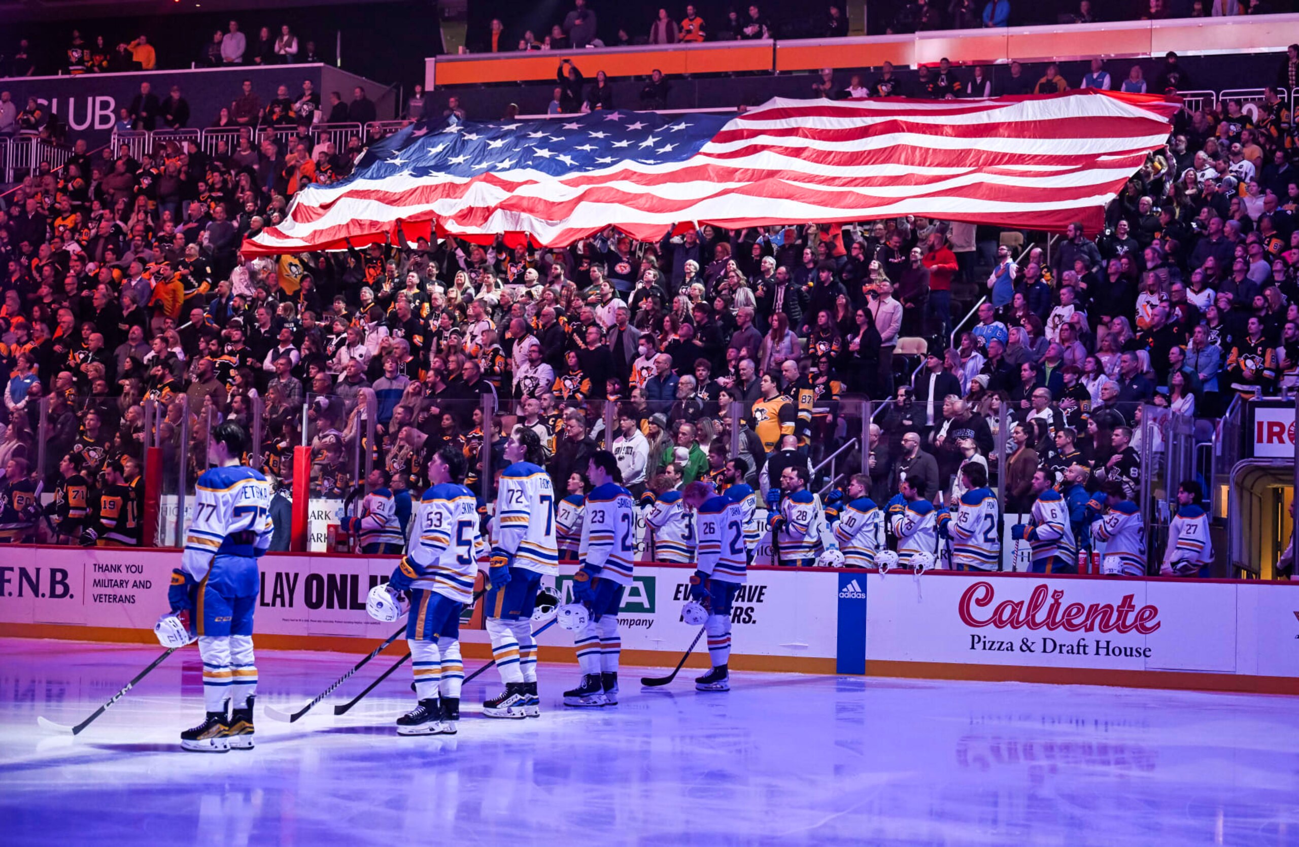 PITTSBURGH, PA - NOVEMBER 11: A larger American flag is displayed in the crowd during the National Anthem prior to the first period in the NHL game between the Pittsburgh Penguins and the Buffalo Sabres on November 11, 2023, at PPG Paints Arena in Pittsburgh, PA. (Photo by Jeanine Leech/Icon Sportswire via Getty Images)