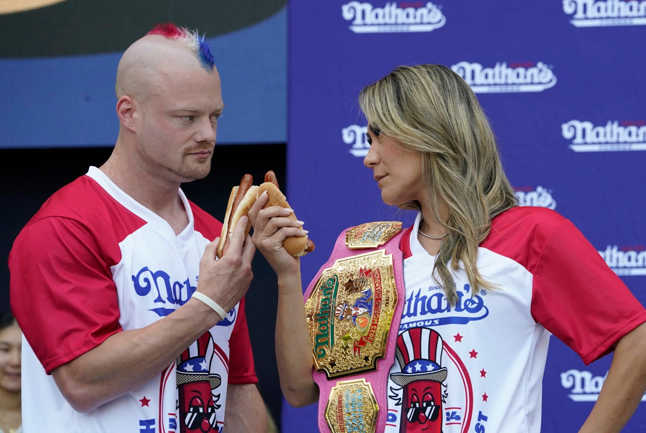(L-R Nick Wehry and Miki Sudo do a stare-down during a weigh-in for the 2024 Nathan's Famous Fourth of July International Hot Dog-Eating Championship at Hudson Yards in New York City on July 3, 2024. The contest will take place in Coney Island, New York on July 4, 2024. (Photo by TIMOTHY A. CLARY / AFP) (Photo by TIMOTHY A. CLARY/AFP via Getty Images)