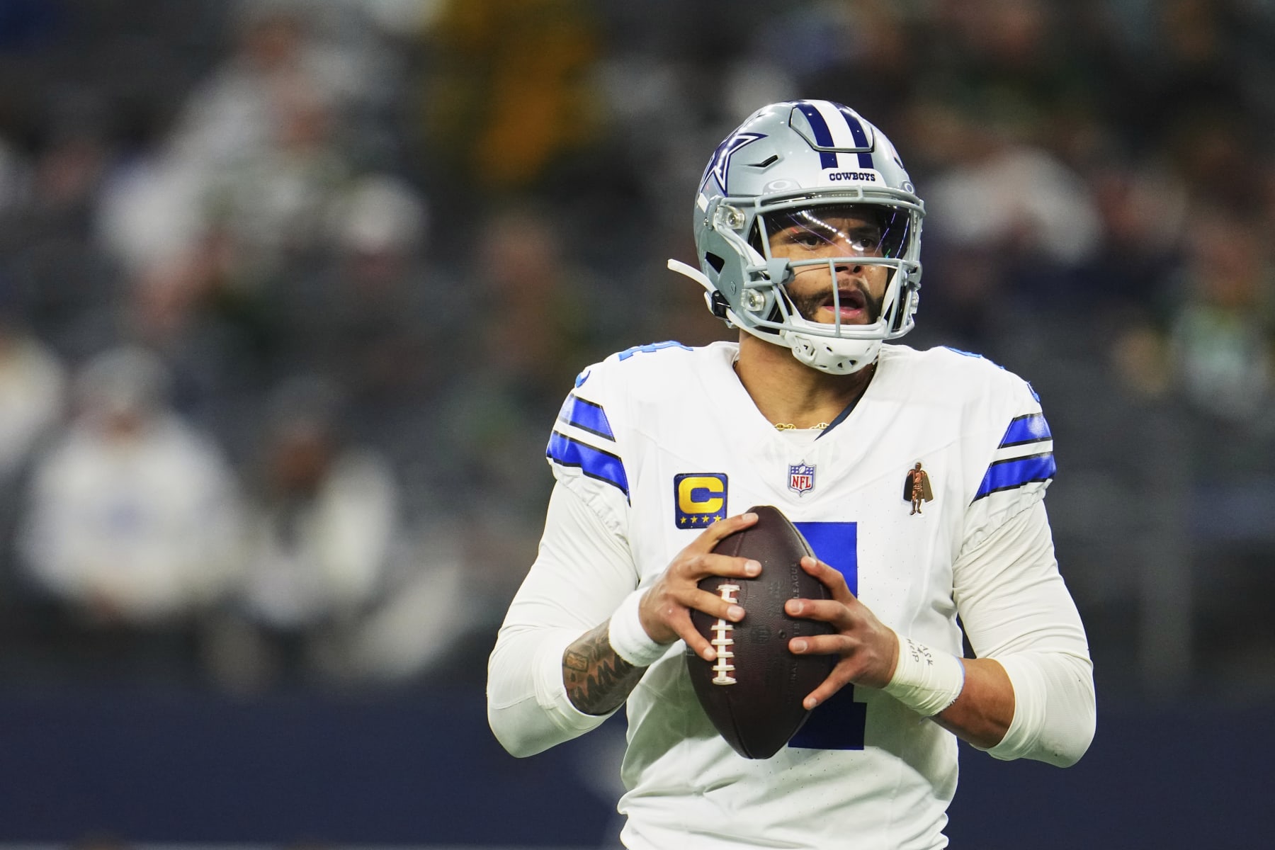DALLAS, TX - JANUARY 14: Dak Prescott #4 of the Dallas Cowboys drops back to pass against the Green Bay Packers during the second half of the NFC Wild Card playoff game at AT&T Stadium on January 14, 2024 in Dallas, Texas. (Photo by Cooper Neill/Getty Images) DALLAS, TX - JANUARY 14: Dak Prescott #4 of the Dallas Cowboys drops back to pass against the Green Bay Packers during the second half of the NFC Wild Card playoff game at AT&T Stadium on January 14, 2024 in Dallas, Texas. (Photo by Cooper Neill/Getty Images)