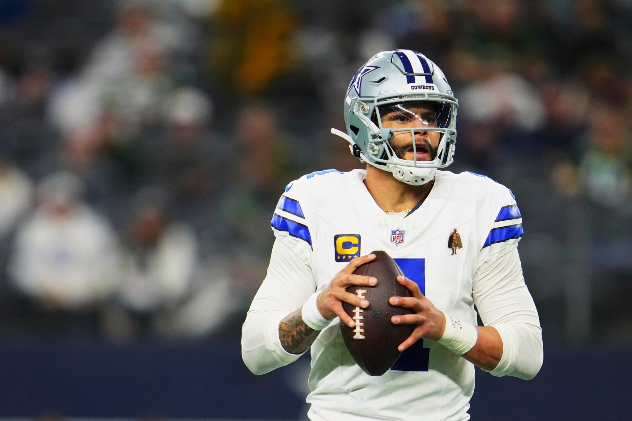DALLAS, TX - JANUARY 14: Dak Prescott #4 of the Dallas Cowboys drops back to pass against the Green Bay Packers during the second half of the NFC Wild Card playoff game at AT&T Stadium on January 14, 2024 in Dallas, Texas. (Photo by Cooper Neill/Getty Images) DALLAS, TX - JANUARY 14: Dak Prescott #4 of the Dallas Cowboys drops back to pass against the Green Bay Packers during the second half of the NFC Wild Card playoff game at AT&T Stadium on January 14, 2024 in Dallas, Texas. (Photo by Cooper Neill/Getty Images)