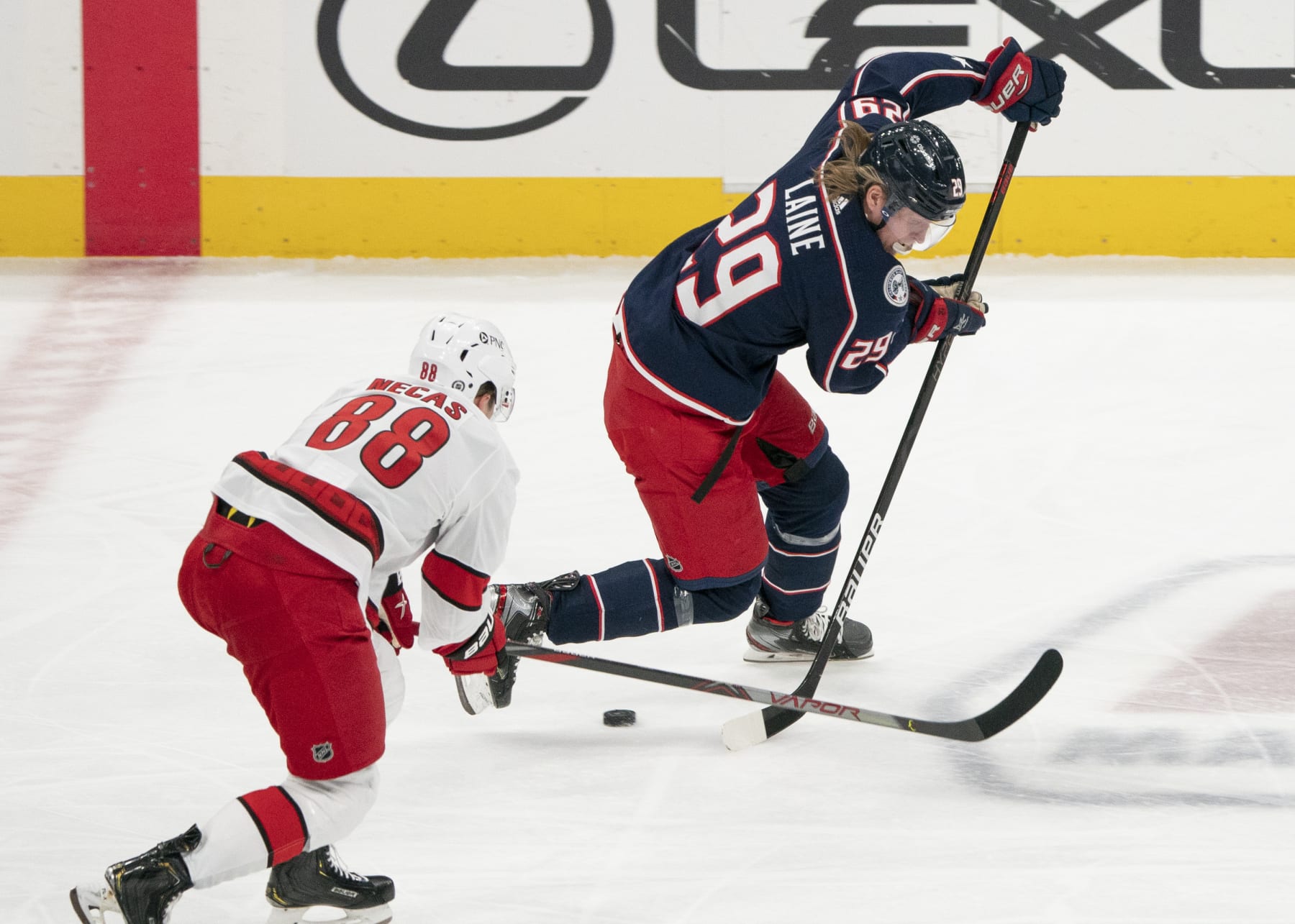 Columbus Blue Jackets winger Patrik Laine (right) and Carolina Hurricanes winger Martin Necas. 