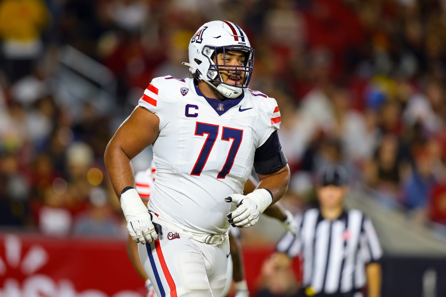 LOS ANGELES, CA - OCTOBER 07: Arizona Wildcats offensive lineman Jordan Morgan (77) runs off of the field during a college football game between the Arizona Wildcats against the USC Trojans on October 07, 2023, at United Airlines Field at The Los Angeles Memorial Coliseum in Los Angeles, CA.(Photo by Jordon Kelly/Icon Sportswire via Getty Images)