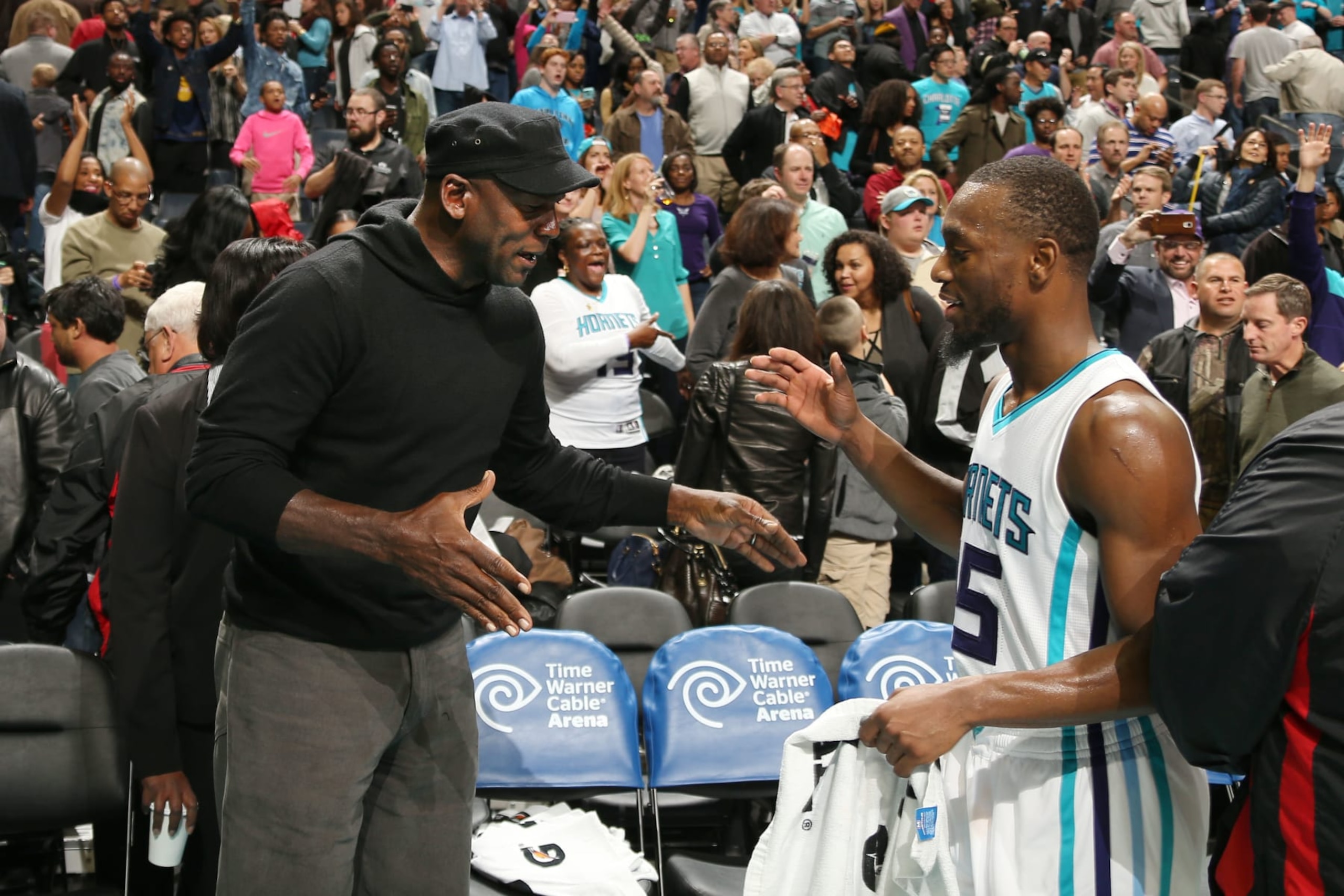 CHARLOTTE, NC - NOVEMBER 25: Hornets owner Michael Jordan high fives Kemba Walker #15 after the game against the Washington Wizards during the game on November 25, 2015 at Time Warner Cable Arena in Charlotte, North Carolina. NOTE TO USER: User expressly acknowledges and agrees that, by downloading and or using this Photograph, user is consenting to the terms and conditions of the Getty Images License Agreement. Mandatory Copyright Notice: Copyright 2015 NBAE (Photo by Kent Smith/NBAE via Getty Images)