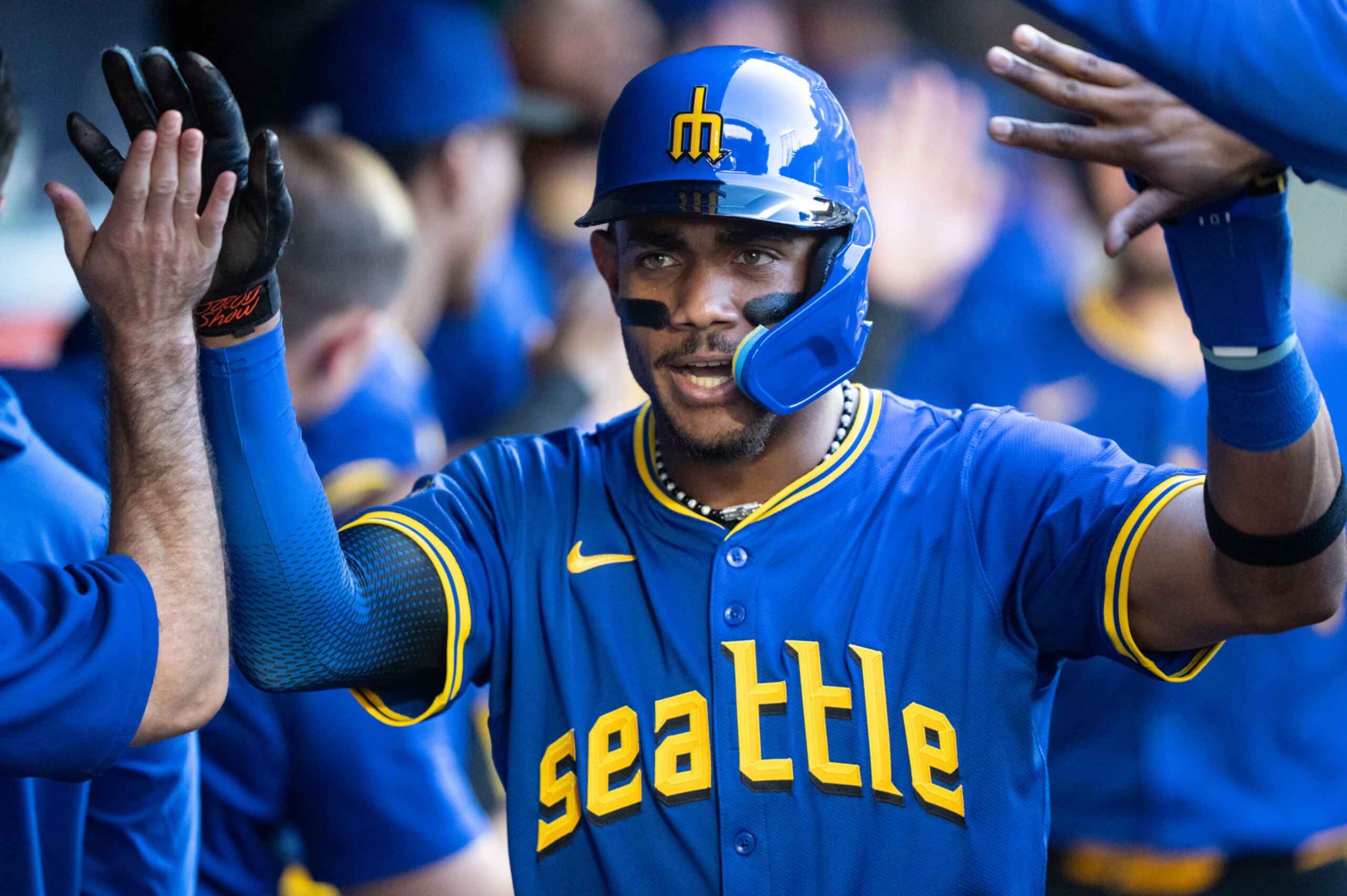 SEATTLE, WA - JULY  05: Julio Rodriguez #44 of the Seattle Mariners celebrates in the dugout after scoring a run during the third inning of a game against the Toronto Blue Jays at T-Mobile Park on July 5, 2024 in Seattle, Washington. (Photo by Stephen Brashear/Getty Images)