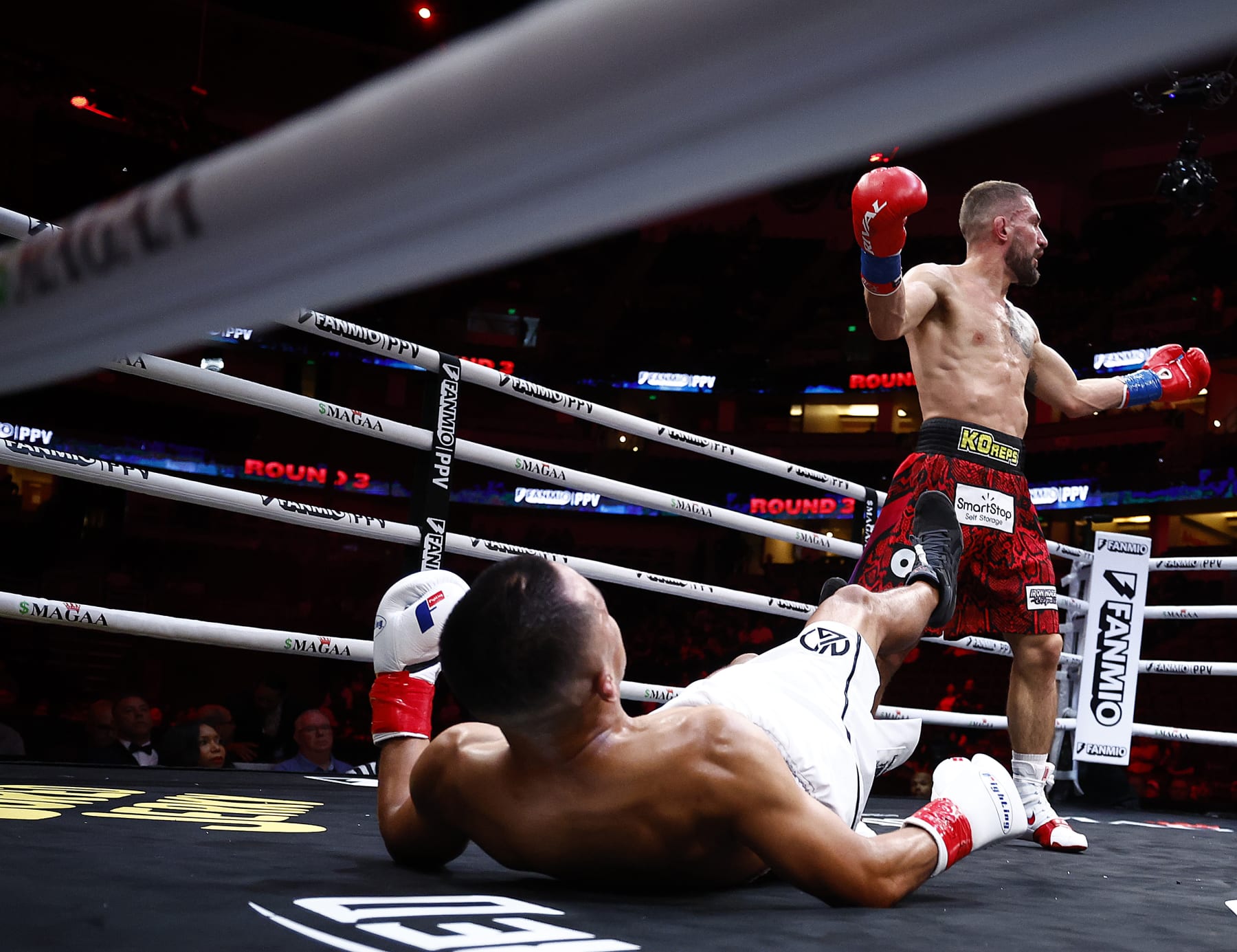 ANAHEIM, CALIFORNIA - JULY 06:  (L-R) Jose Aguayo falls against Bryce Logan during round four of their junior middleweights fight at Honda Center on July 06, 2024 in Anaheim, California. (Photo by Ronald Martinez/Getty Images)