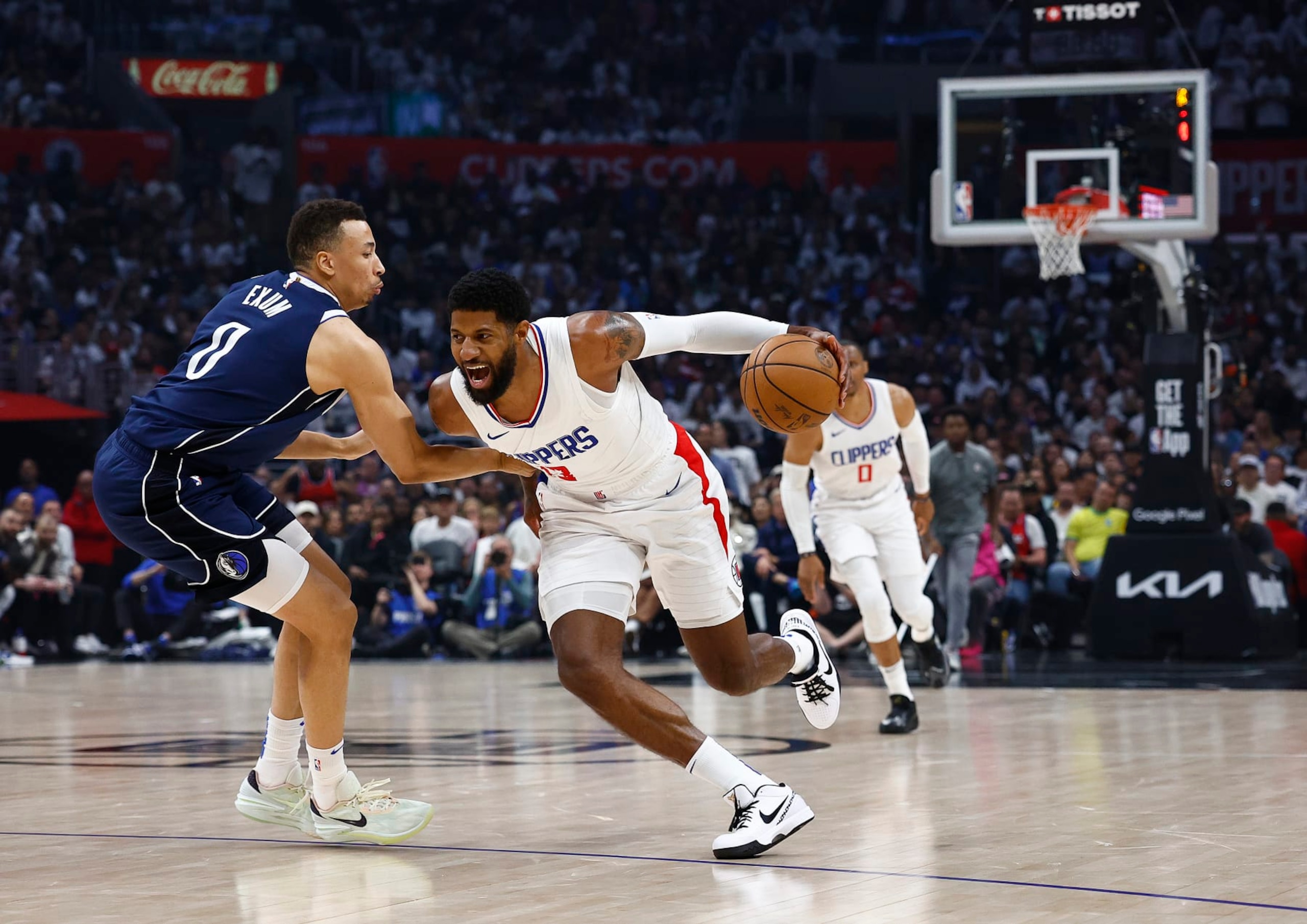LOS ANGELES, CALIFORNIA - MAY 01:  Paul George #13 of the LA Clippers controls the ball against Dante Exum #0 of the Dallas Mavericks during game five of the Western Conference First Round Playoffs at Crypto.com Arena on May 01, 2024 in Los Angeles, California.  NOTE TO USER: User expressly acknowledges and agrees that, by downloading and/or using this photograph, user is consenting to the terms and conditions of the Getty Images License Agreement.  (Photo by Ronald Martinez/Getty Images)