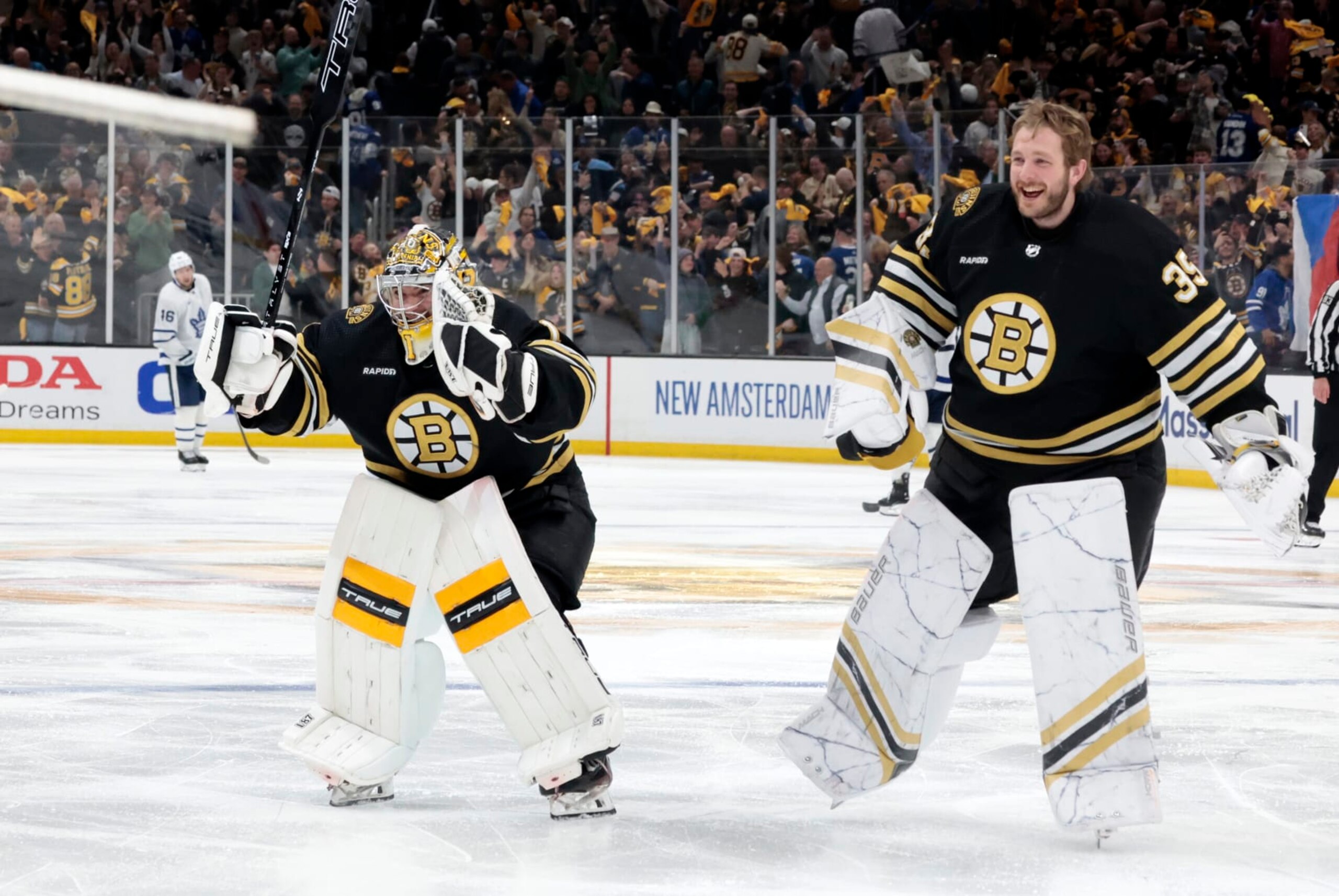 BOSTON, MA - MAY 04: Boston Bruins goalie Jeremy Swayman (1) and Boston Bruins goalie Linus Ullmark (35) rush to teammates after Game 7 of the Eastern Conference First Round playoffs between the Boston Bruins and the Toronto Maple Leafs on May 4, 2024, at TD Garden in Boston, Massachusetts. (Photo by Fred Kfoury III/Icon Sportswire via Getty Images)