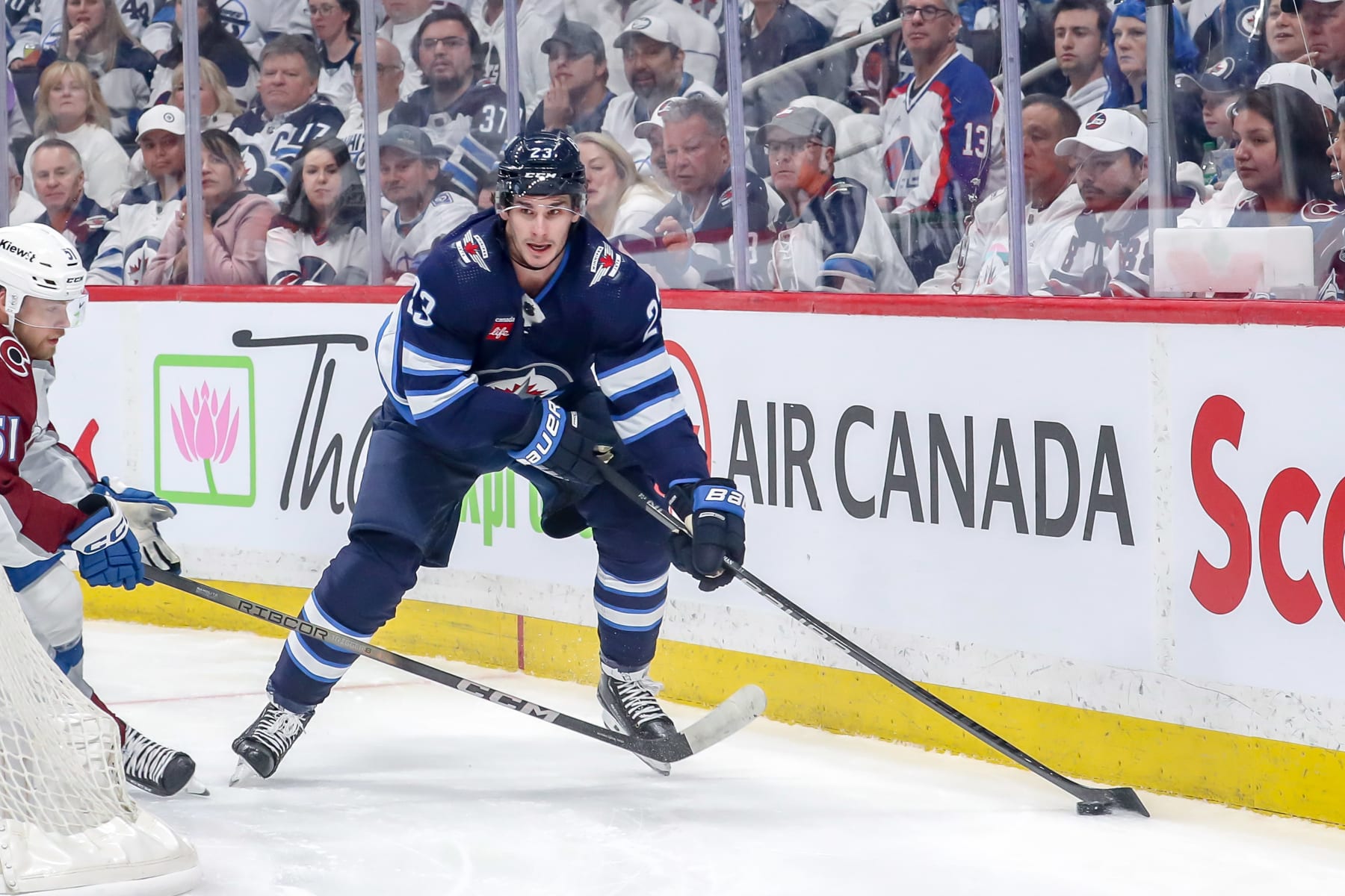 WINNIPEG, CANADA - APRIL 30: Sean Monahan #23 of the Winnipeg Jets plays the puck behind the net during first period action against the Colorado Avalanche in Game Five of the First Round of the 2024 Stanley Cup Playoffs at the Canada Life Centre on April 30, 2024 in Winnipeg, Manitoba, Canada. The Avs defeated the Jets 6-3 and win the series 4-1. (Photo by Darcy Finley/NHLI via Getty Images)