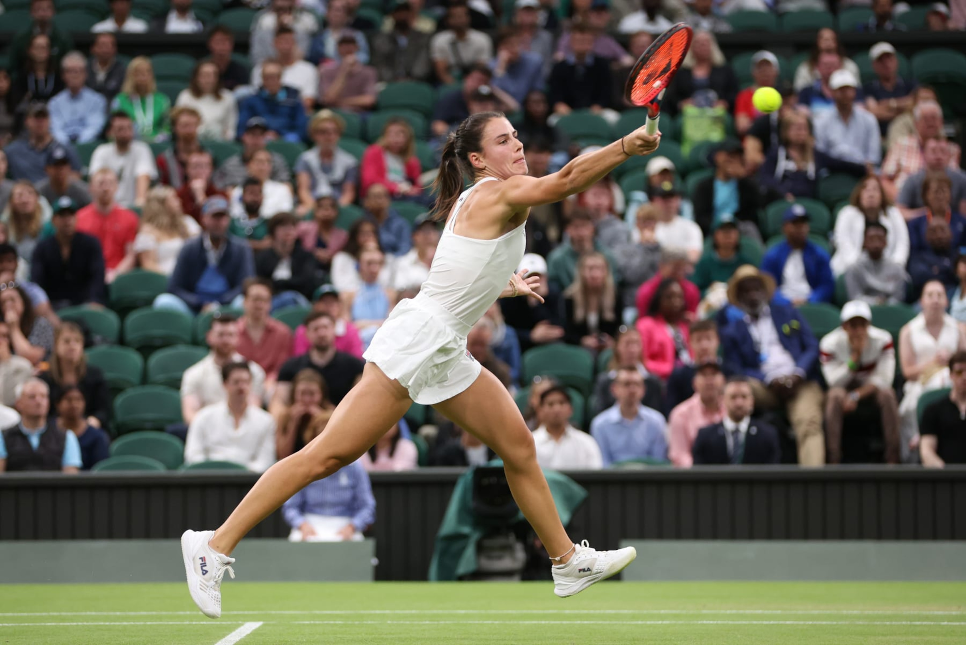 LONDON, ENGLAND - JULY 07: Emma Navarro of United States plays a forehand against Coco Gauff of United States in the Ladies' Singles fourth round match during day seven of The Championships Wimbledon 2024 at All England Lawn Tennis and Croquet Club on July 07, 2024 in London, England. (Photo by Clive Brunskill/Getty Images)