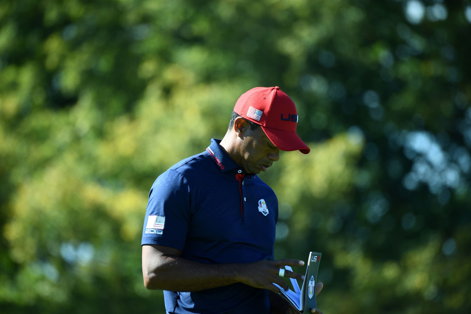 US golfer Tiger Woods looks at his notepad  during his singles match with Europe's Spanish golfer Jon Rahm  on the third day of the 42nd Ryder Cup at Le Golf National Course at Saint-Quentin-en-Yvelines, south-west of Paris, on September 30, 2018. (Photo by FRANCK FIFE / AFP)        (Photo credit should read FRANCK FIFE/AFP via Getty Images)