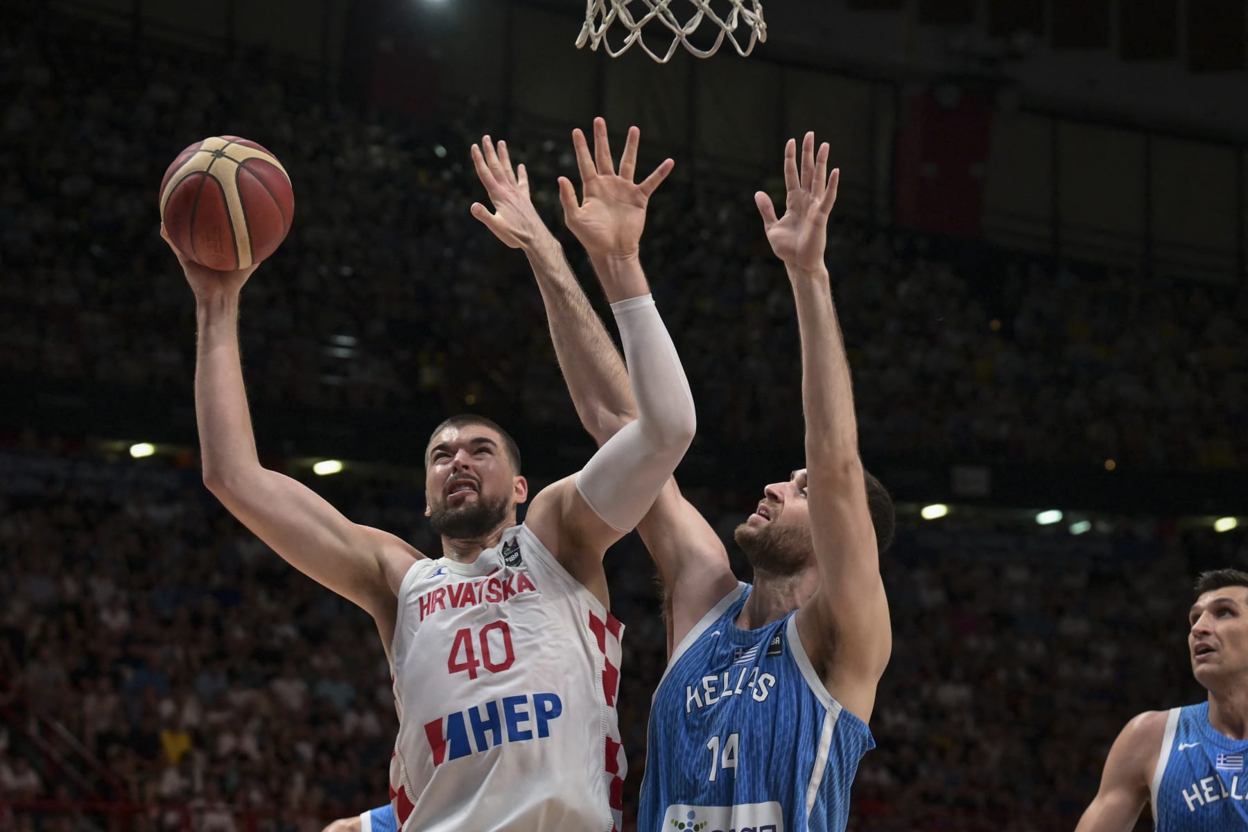 Croatia's Ivica Zubac (L) is marked by Greece's Georgios Papagiannis (C) during the final game of the FIBA Olympic Qualifying Tournament between Croatia and Greece at the Peace and Friendship Stadium in Athens on July 7, 2024. (Photo by Aris MESSINIS / AFP) (Photo by ARIS MESSINIS/AFP via Getty Images)