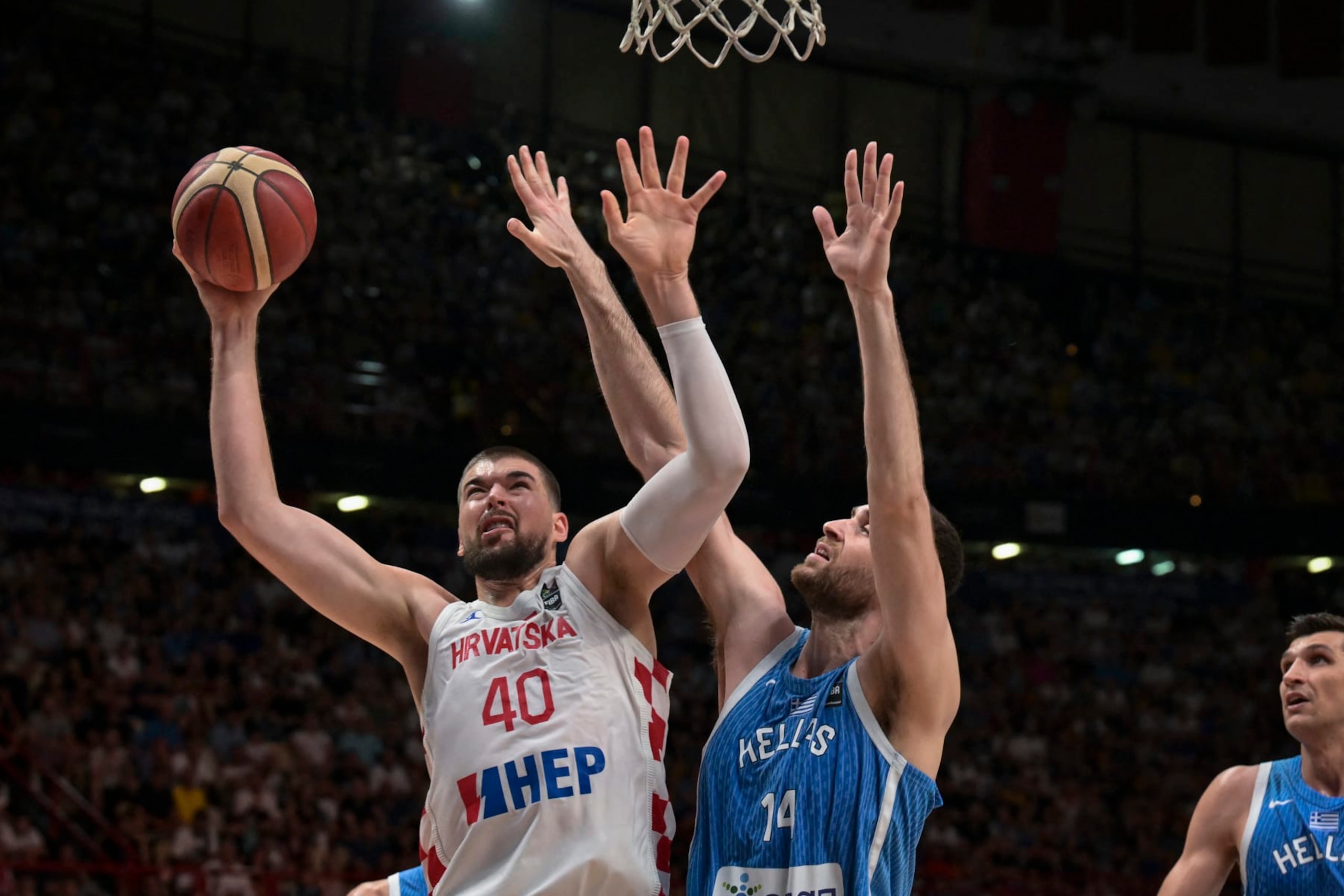 Croatia's Ivica Zubac (L) is marked by Greece's Georgios Papagiannis (C) during the final game of the FIBA Olympic Qualifying Tournament between Croatia and Greece at the Peace and Friendship Stadium in Athens on July 7, 2024. (Photo by Aris MESSINIS / AFP) (Photo by ARIS MESSINIS/AFP via Getty Images)