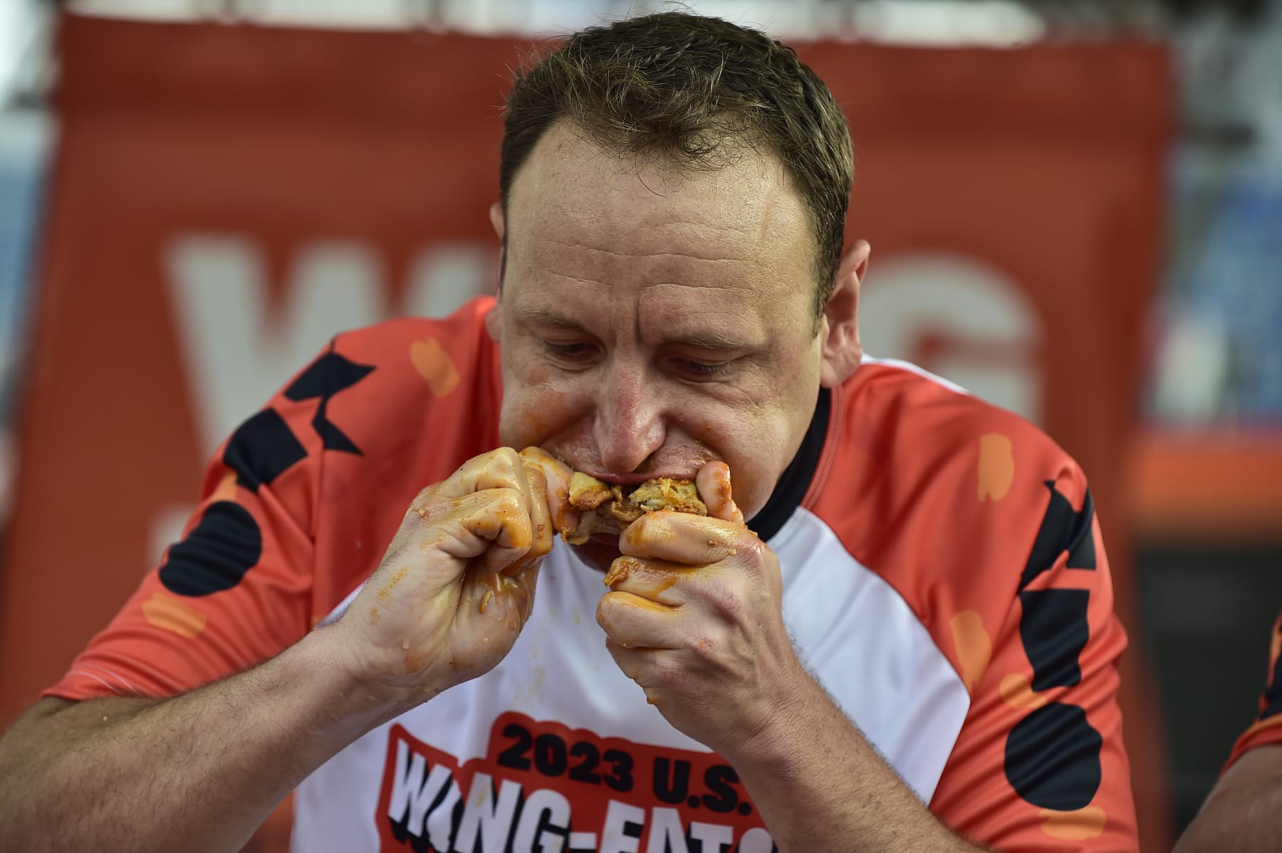 BUFFALO, NEW YORK - SEPTEMBER 3: Joey Chestnut takes part in the National Chicken Wing Eating Contest on September 3, 2023 at Highmark Stadium, home of the NFL Buffalo Bills in Orchard Park, New York. The festival, now in its 22nd year,  averages more than 45,000 attendees from all 50 states and 44 countries. It has served up over 5.7 million chicken wings and raised more than $440,000 for local charities. (Photo by John Normile/Getty Images)