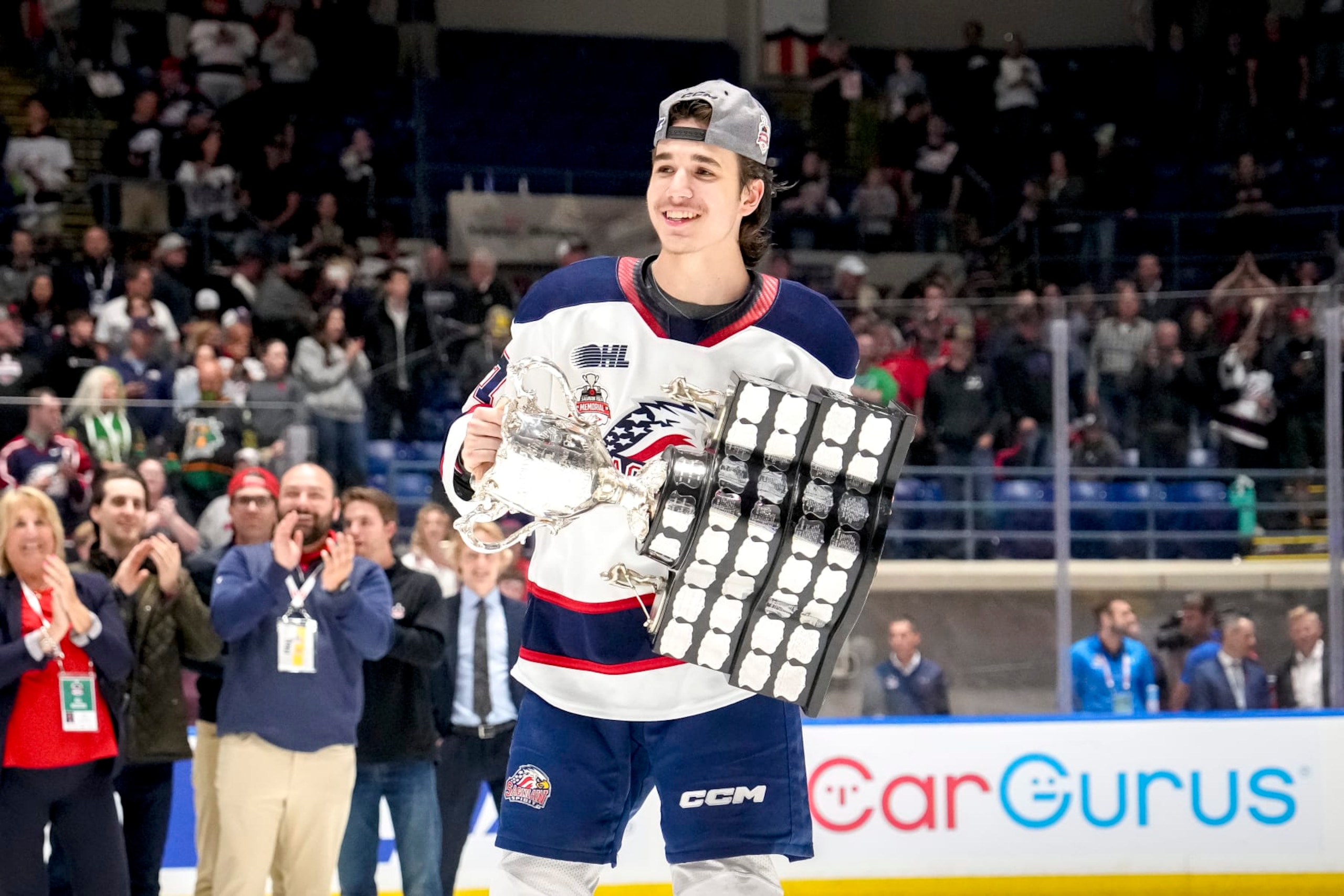SAGINAW, MICHIGAN - JUNE 02: Michael Misa #77 of the Saginaw Spirit celebrates with the Memorial Cup after defeating the London Knights in the 2024 Memorial Cup Final at Dow Event Center on June 02, 2024 in Saginaw, Michigan. (Photo by Nic Antaya/Getty Images)