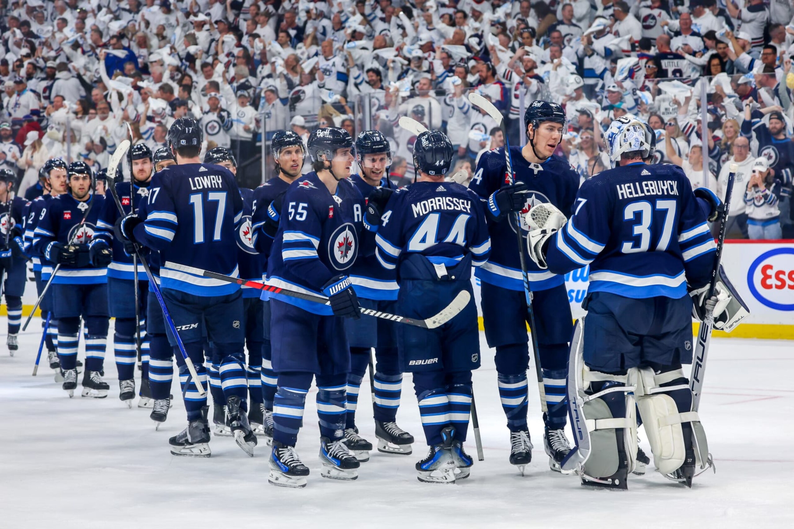 WINNIPEG, CANADA - APRIL 21: Members of the Winnipeg Jets congratulate goaltender Connor Hellebuyck #37 following a 7-6 victory over the Colorado Avalanche in Game One of the First Round of the 2024 Stanley Cup Playoffs at Canada Life Centre on April 21, 2024 in Winnipeg, Manitoba, Canada. (Photo by Jonathan Kozub/NHLI via Getty Images)